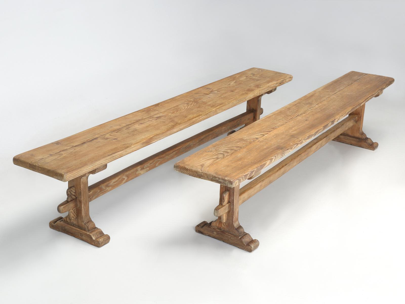Antique pair of scrubbed pine benches, that were probably used in conjunction with an old farm style dining table. Our Old Plank restoration department rebuilt the benches structurally and our finishing department just applied a protective