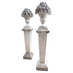 Pair of Sculpted Italian Limestone Fruit Baskets on Tall Tapered Plinths