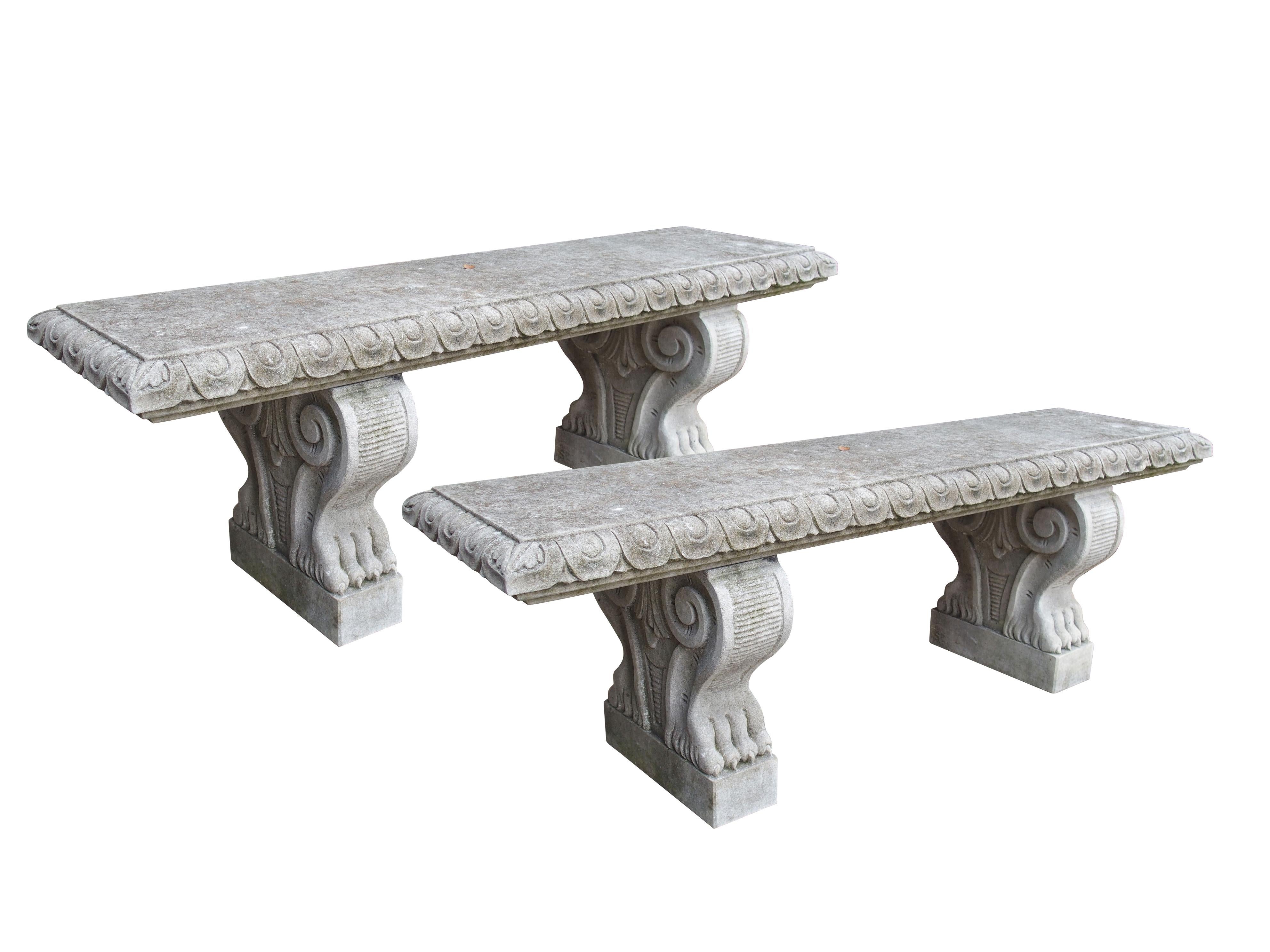 From Italy, this pair of charming limestone garden benches have been hand-carved out of Vicenza limestone. The grey-colored stone has weathered nicely, leading to white, dark grey, and black patinas showing.

A recessed egg and dart molding with