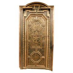 Pair of sculpted, lacquered and gilded interior doors, original frame, Florence