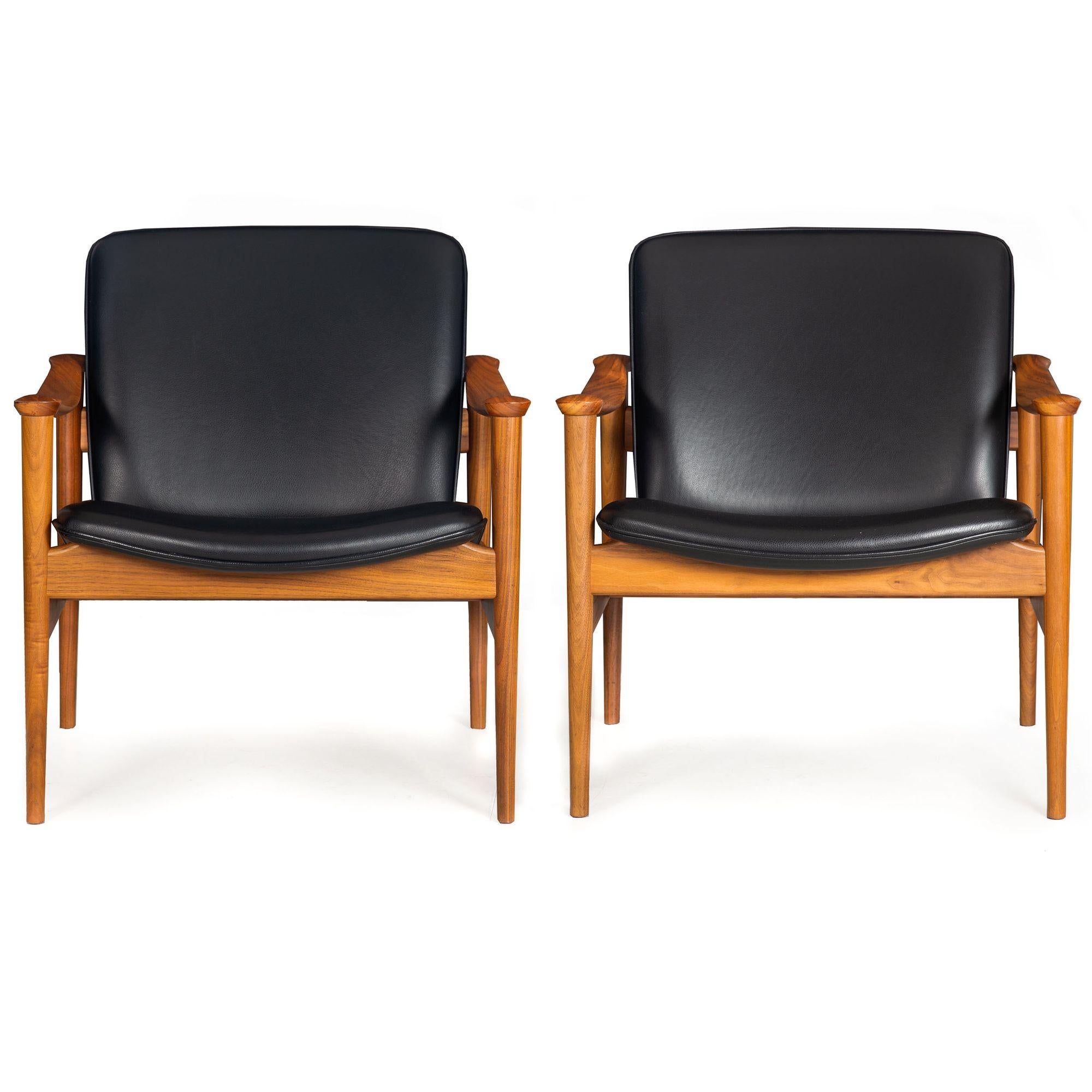 PAIR OF SCULPTED WALNUT MODEL NO. 711 LOUNGE CHAIRS
Designed by Frederik Kayser in 1961, produced by LK Hjelle, Norway, ca. 21st century  retails new for $ 4400-4900/each
Item # 312NWT08A

An exceedingly beautiful pair of chairs originally designed