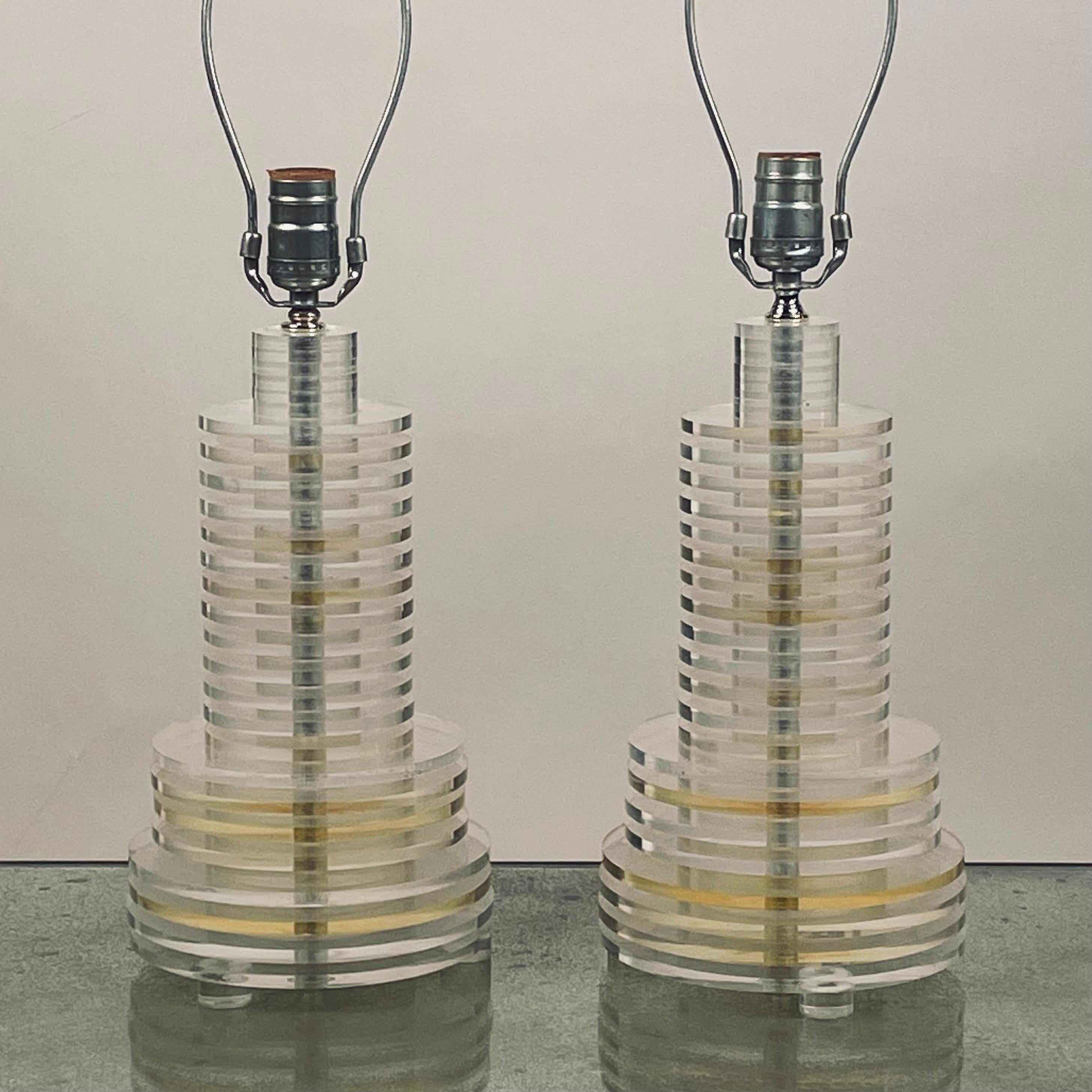 Pair of sculptural 70's clear and tinted lucite disc lamps.

Dimensions listed are for the lamp bases (to the finals). Shades are not included.