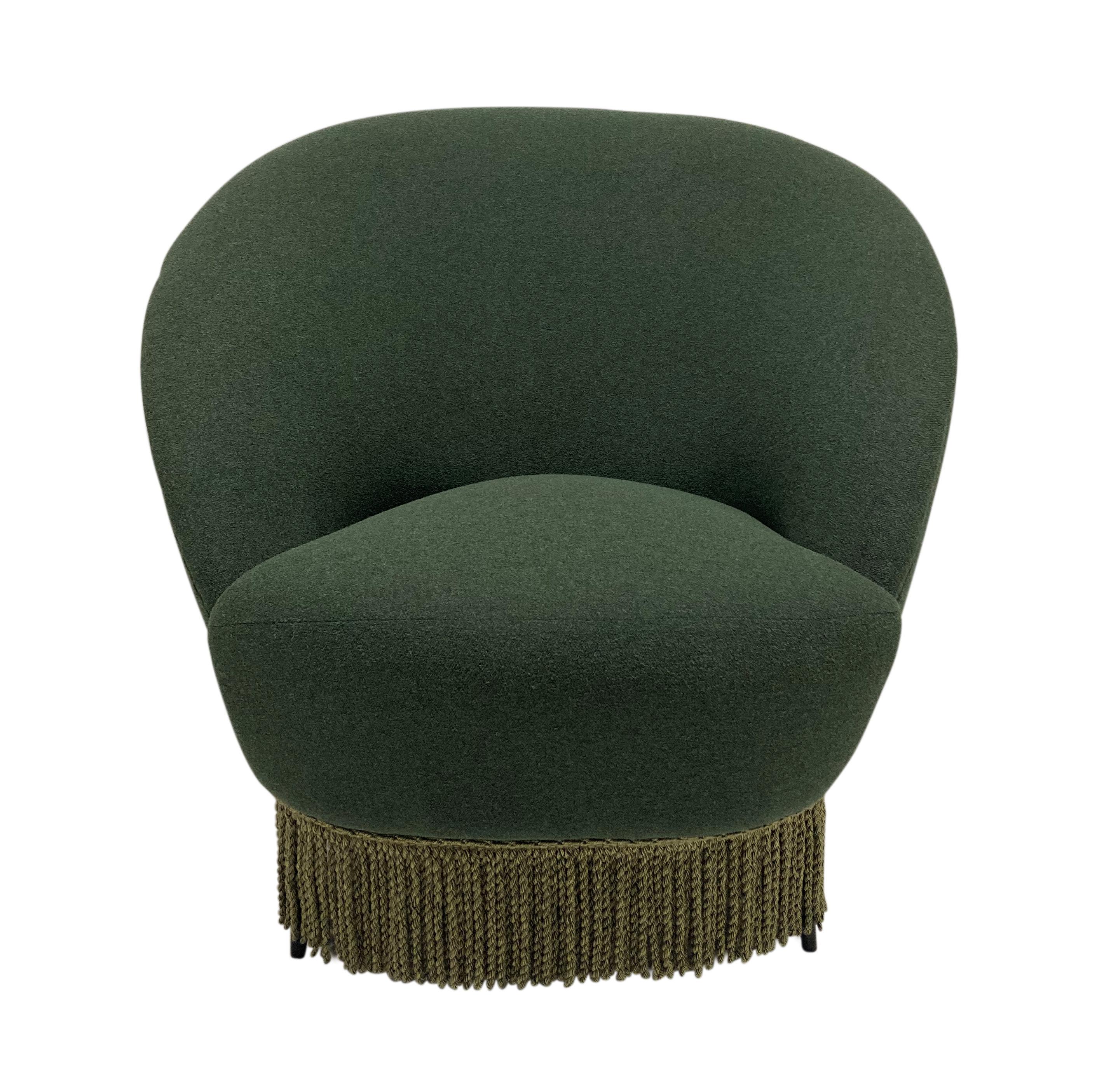 A fine pair of Italian sculptural armchairs by Federico Munari. Designed to be both beautiful and comfortable. On tapering black lacquered feet., newly upholstered in an olive green wool micro-boucle and with a lighter olive green tassel fringe.