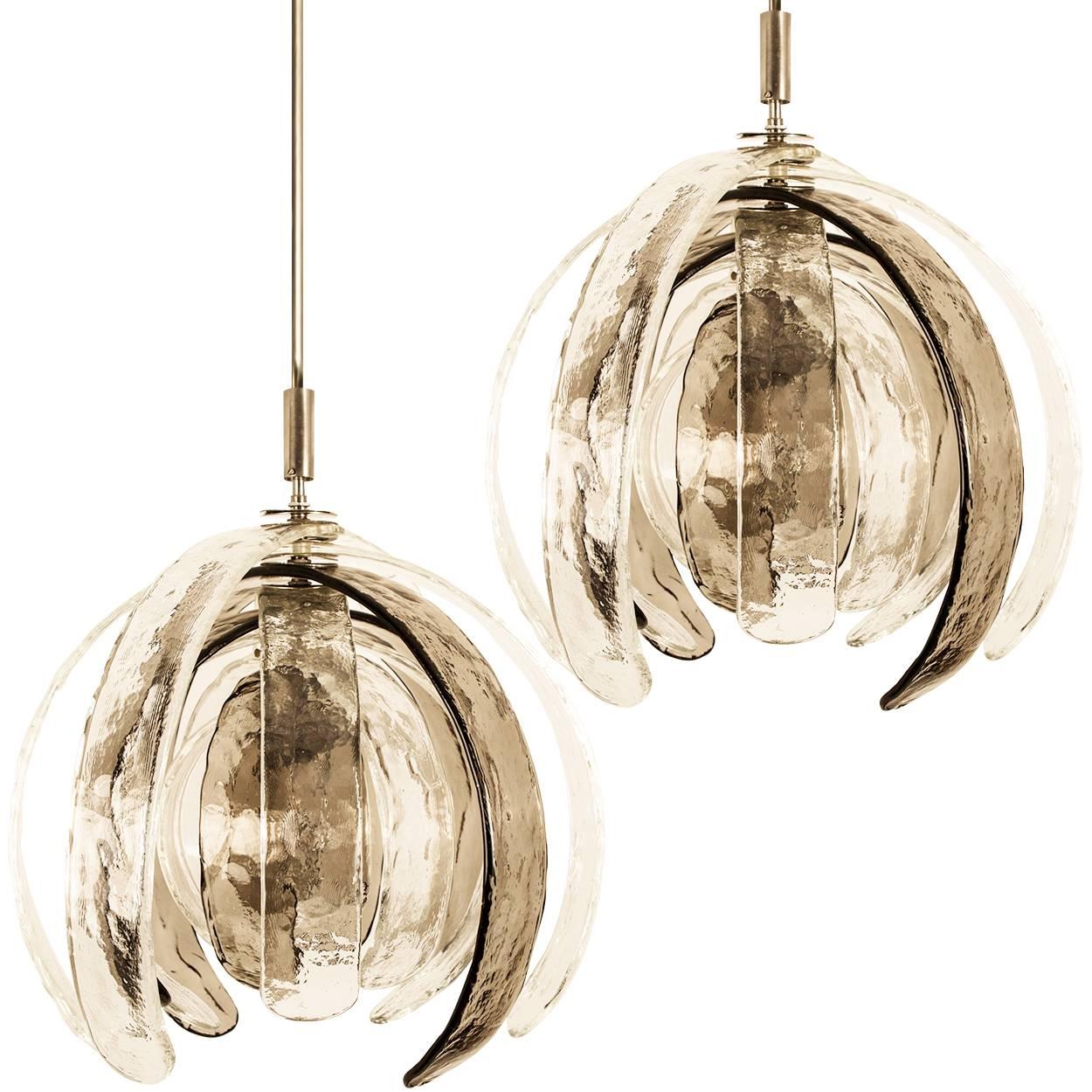 Pair of high-end sculptural artichoke chandeliers by Carlo Nason for Mazzega. Thick clear and bronze pattern glass blades. The blades from big to small can be put in the position of one line as unfolding into a flower. They can rotate independently.