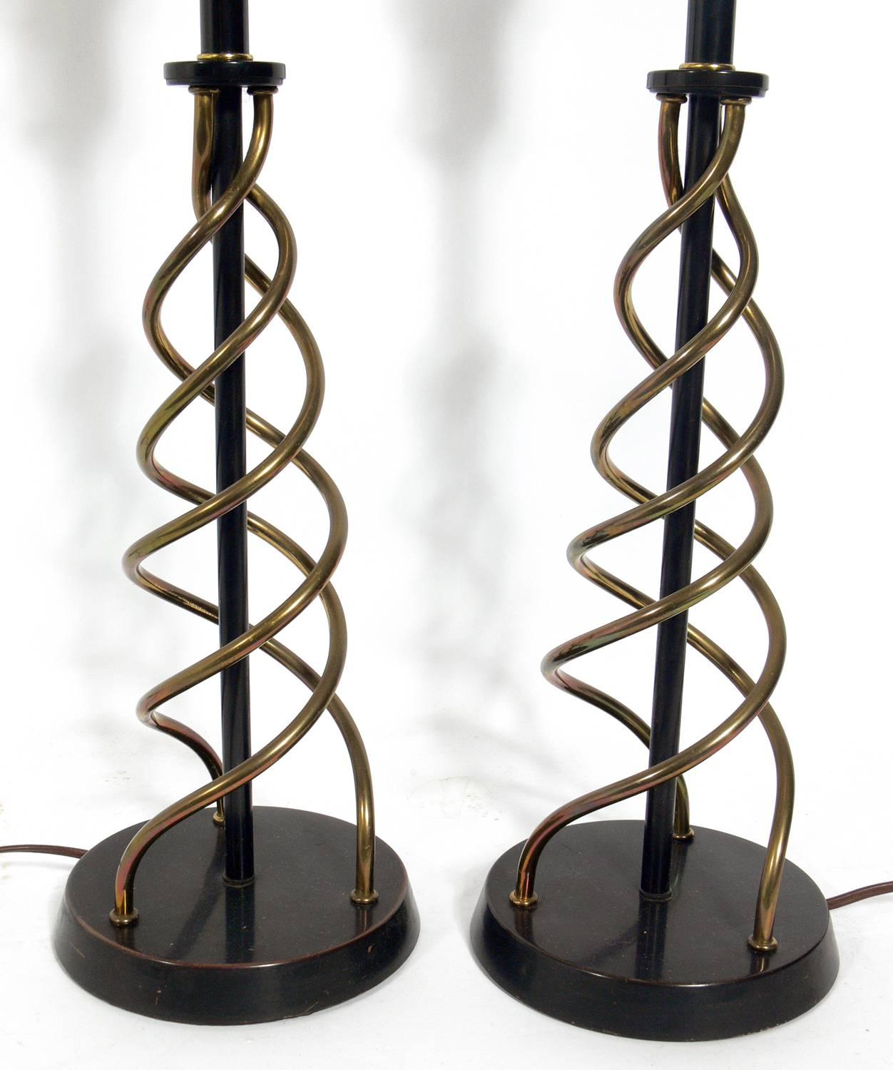 Pair of sculptural brass spiral lamps, American, circa 1950s. Constructed of patinated brass spirals with deep bronze color metal bases and fittings. They have been rewired and are ready to use. The price noted below includes the shades.