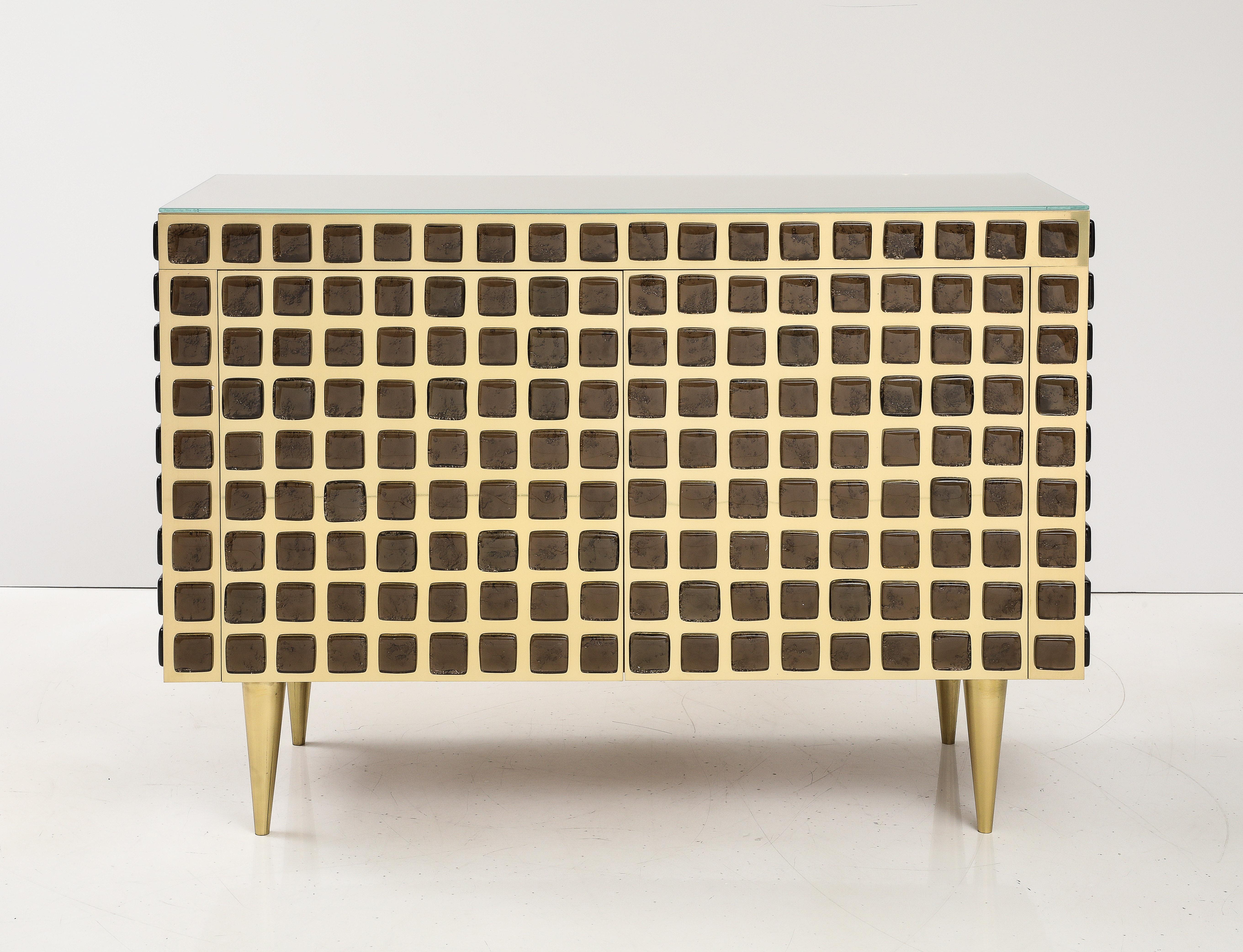One of a kind pair of Bronze colored Murano glass blocks and polished brass cabinets or sideboards hand-made in Florence, Italy by a family of master artisans and artists. Solid wooden body in beechwood is veneered with polished brass plates.