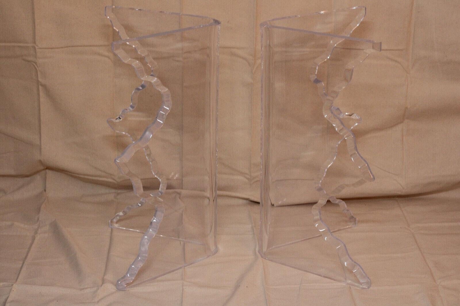 Fabulous vintage pair of 1970s era sculptural Lucite dining table bases in the Hollywood Regency or Mid-Century Modern style. Lucite has a natural transparency, providing a beautifully clean look, and it doesn’t add any visual clutter. These thick