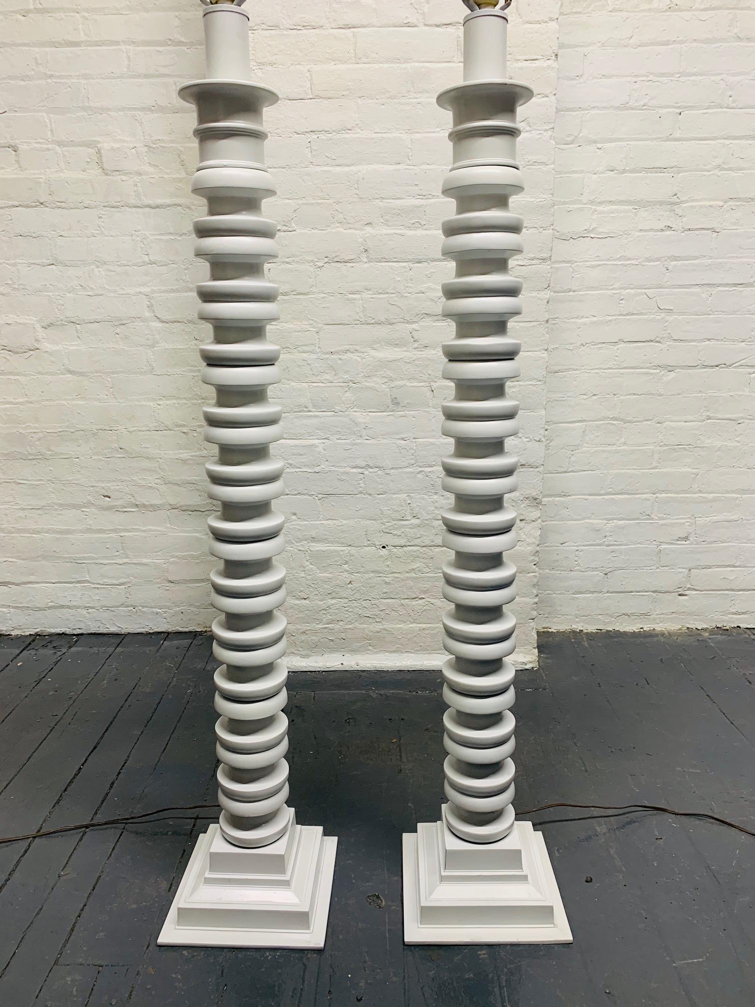Pair of sculptural floor lamps. Lamps have a white lacquered finish.
Measures: 46 height (to under bulb socket). Base: 9 x 9.
  