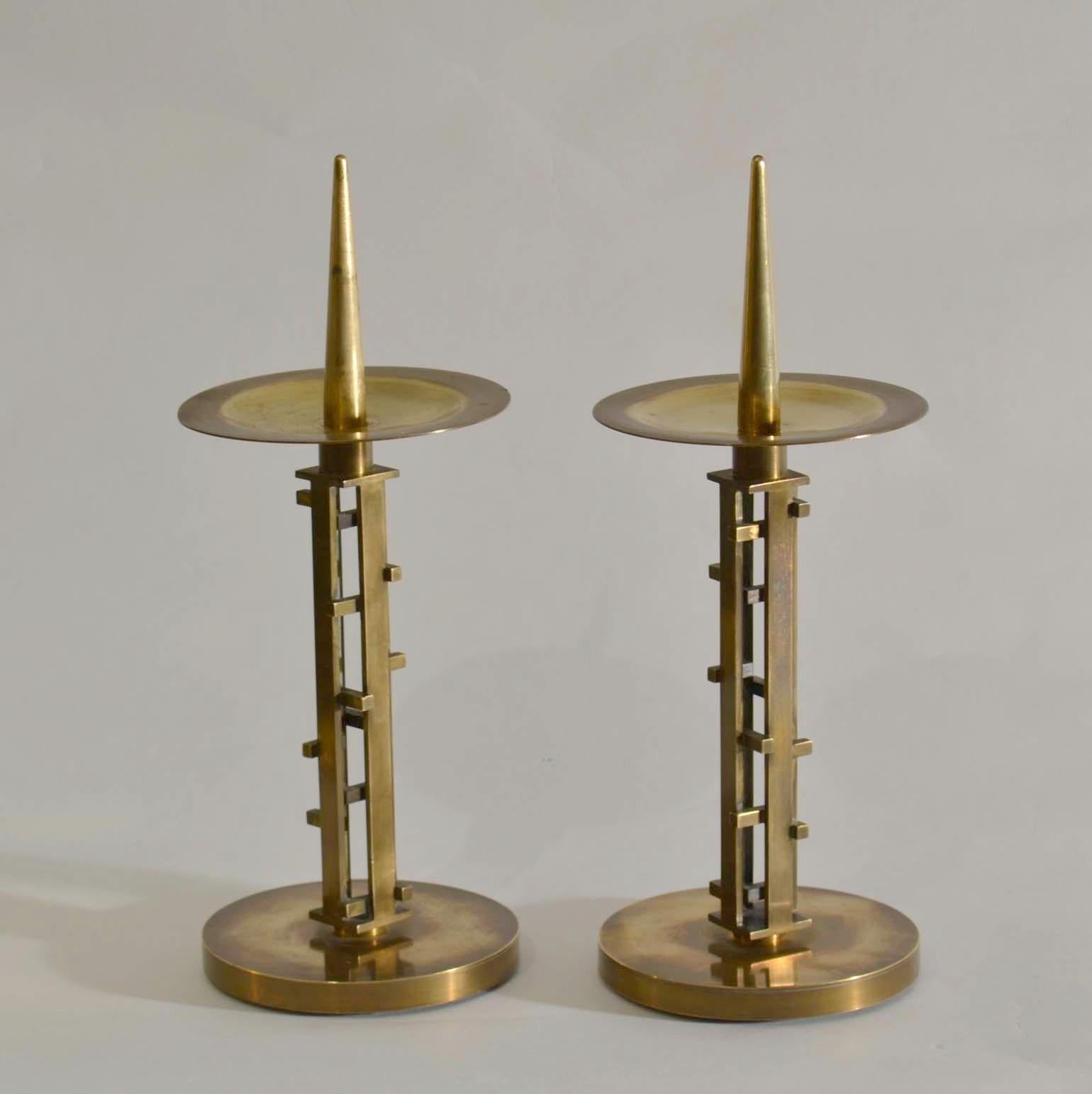 These  exquisite and distinctly designed candlesticks are commonly used in worship both for decoration and ambiance. Geometric sculptural pair of handcrafted candle holders were  assembled by a silversmith using advanced decorative techniques