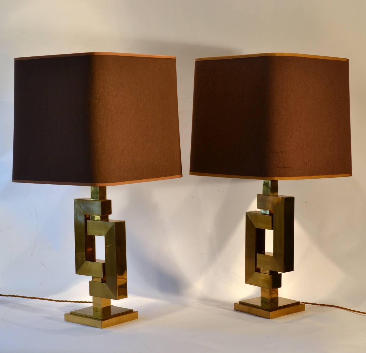 A pair of sculptural table lamps with strong geometric design with square tubular sections in alternating polished and brushed brass finish attributed to Willy Rizzo. The lamps are in excellent condition. The shades are original brown and gold with