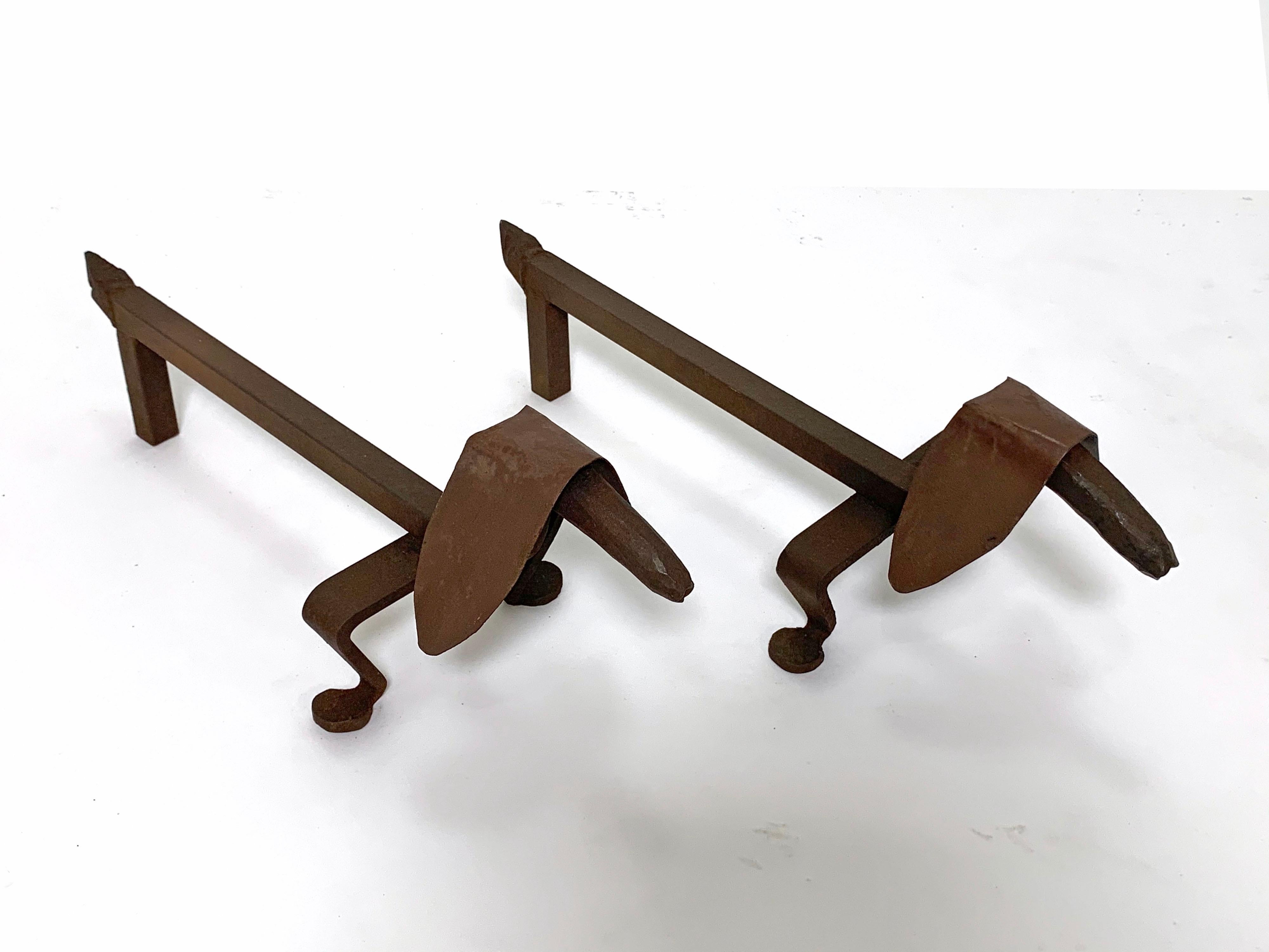 A pair of artist made hand forged wrought iron sculptural andirons in the form of dachshunds, circa 1920s.
    
