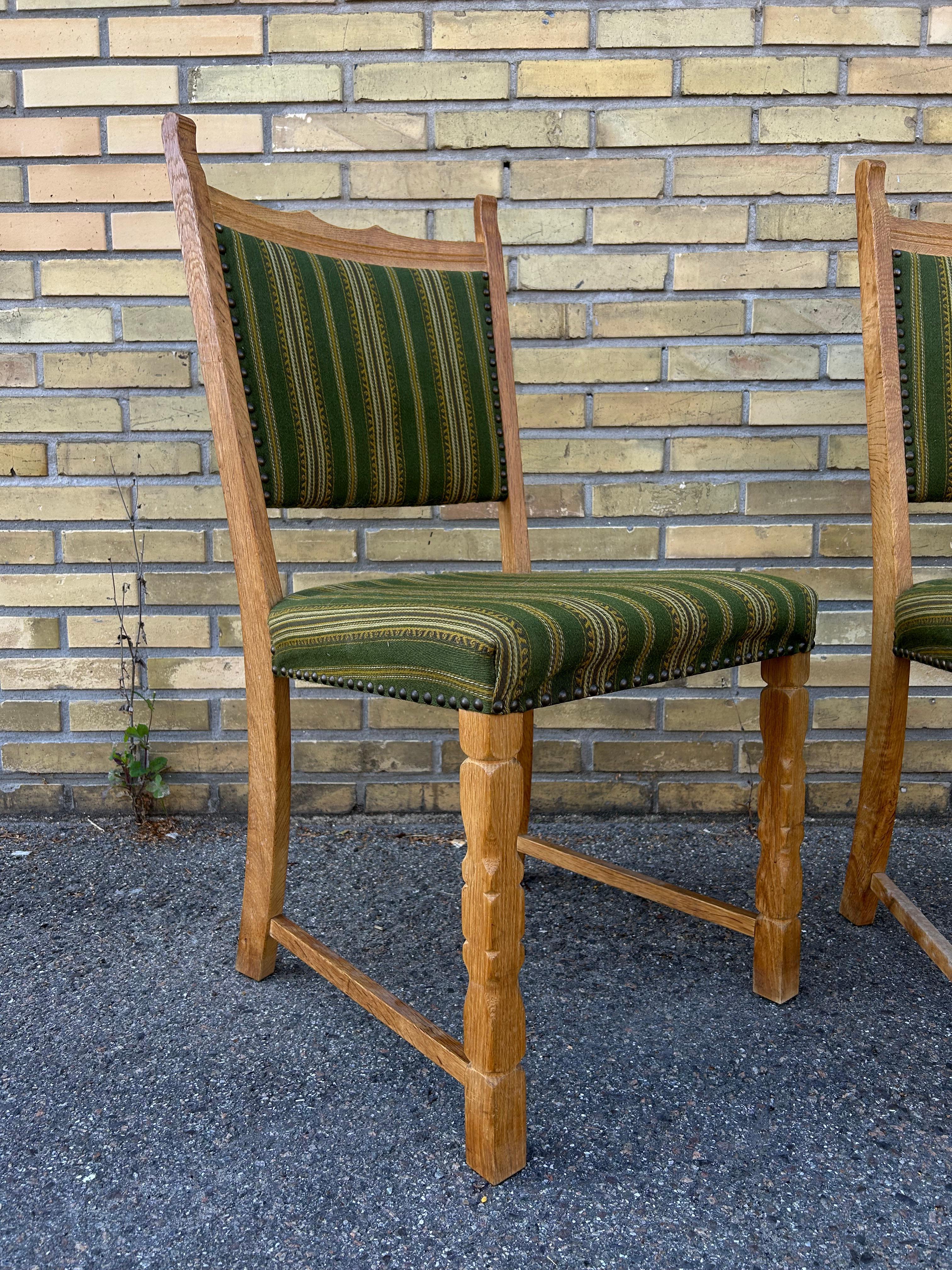 Set of two of very sculptural solid oak side chairs with original striped wool upholstery designed by Danish designer Henry Kjærnulf also known as Henning Kjærnulf and manufactured by Nyrup Møbelfabrik in Denmark in the 1960’s.