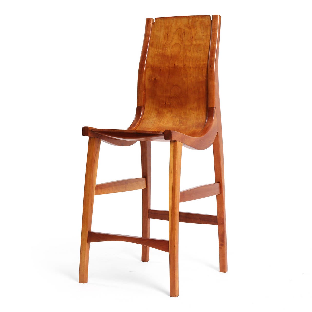 An excellent and unusual set of two (2) American craftsman style tall chairs with a sinuous sculptural form, designed by Jere Osgood. Solid maple seat and back on a laminate platform. Made in the USA, circa 1960s.