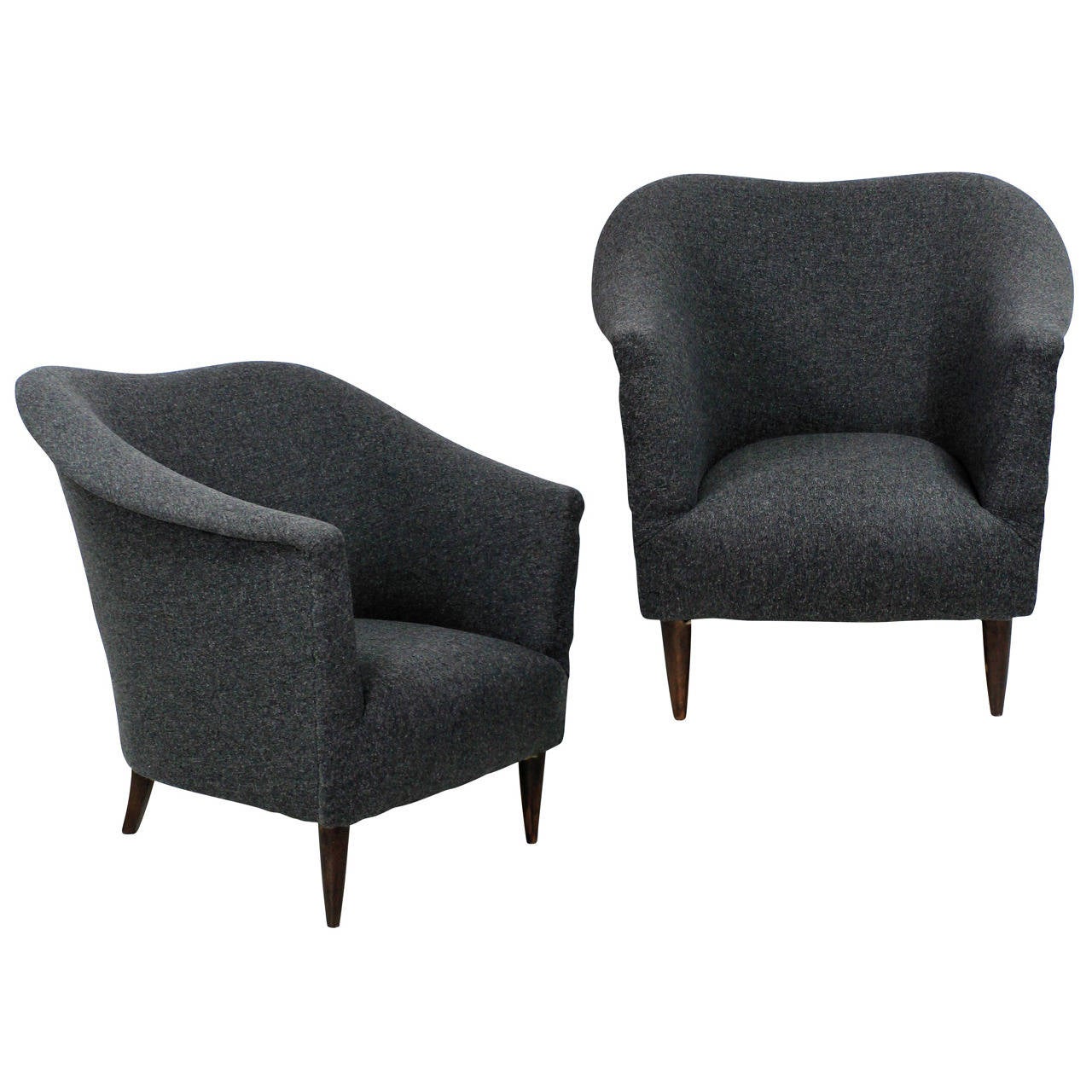 A pair of Italian sculptural armchairs with turned French polished feet and newly upholstered in grey wool.

 