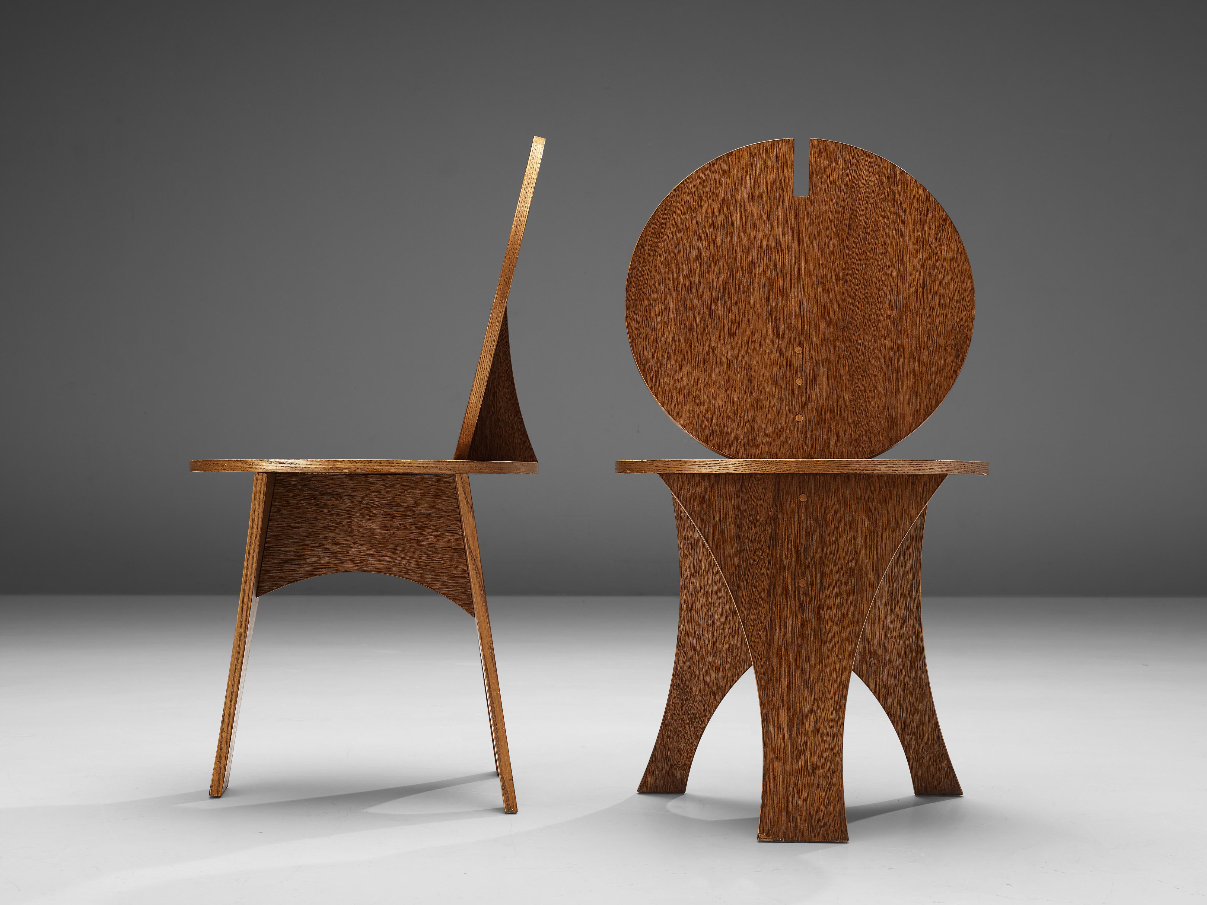 Set of side chairs, wood, Italy, 1970s.

Two sculptural side chairs with characteristic backrests. A flat circular backrest with a geometric gap on top highlights the rare appearance of these two side chairs. The round shape is echoed in the round