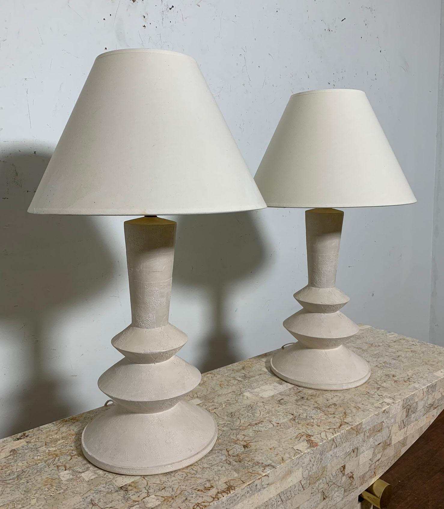 Pair of 1970s era lamps in textured plaster, attributed to Sirmos Lighting, a variation of a design by Alberto & Diego Giacometti for Jean Michel Frank. 

Please note the shades are not included and are shown for proportion only. Final image shows