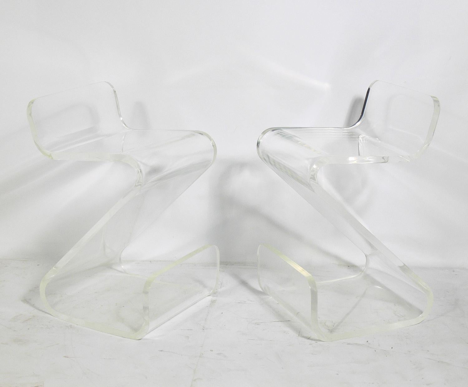 Pair of sculptural Lucite stools, American, circa 1970s. They have been cleaned and polished and are ready to use.