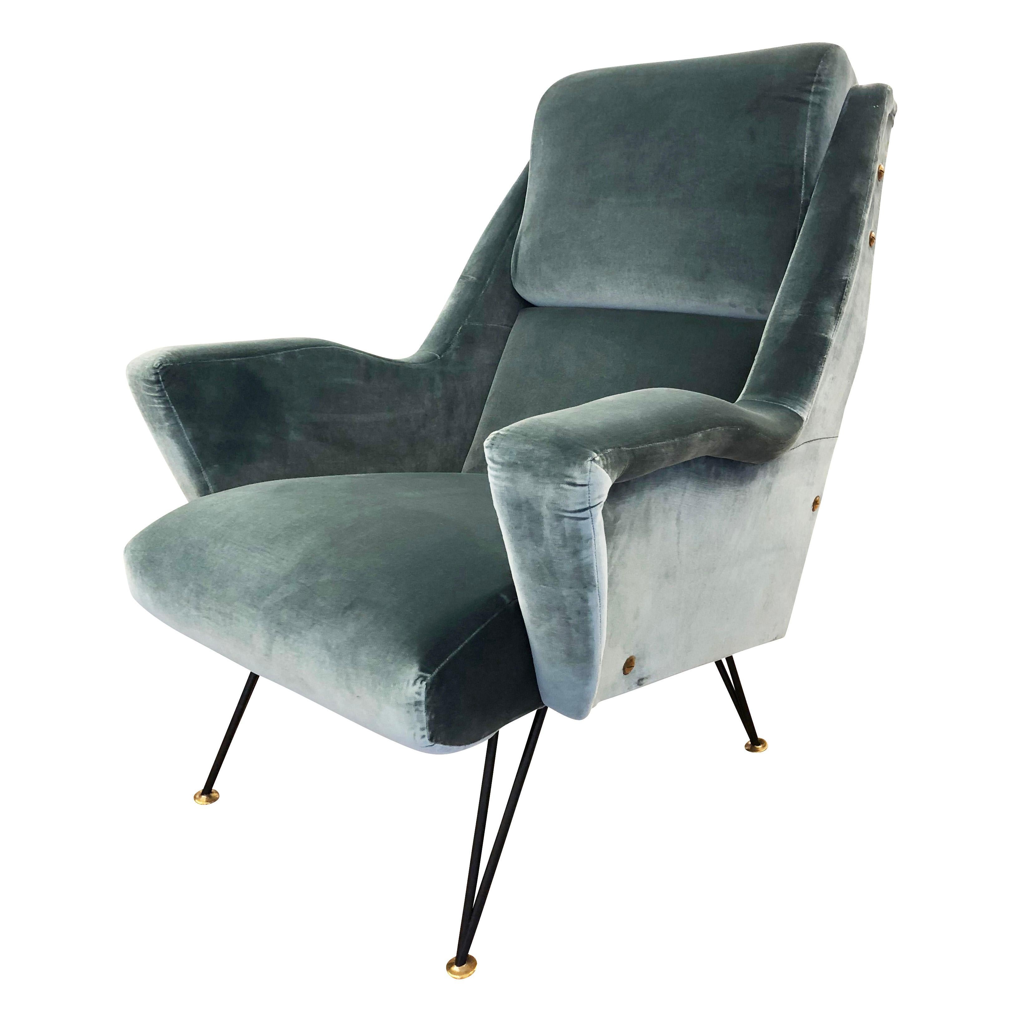 Sculptural pair of Italian Mid-Century lounge chairs upholstered in acqua green velvet. Noteworthy are the shape of the arm rests and legs. Legs are lacquered black with brass feet.

Condition: Excellent vintage condition, minor wear consistent