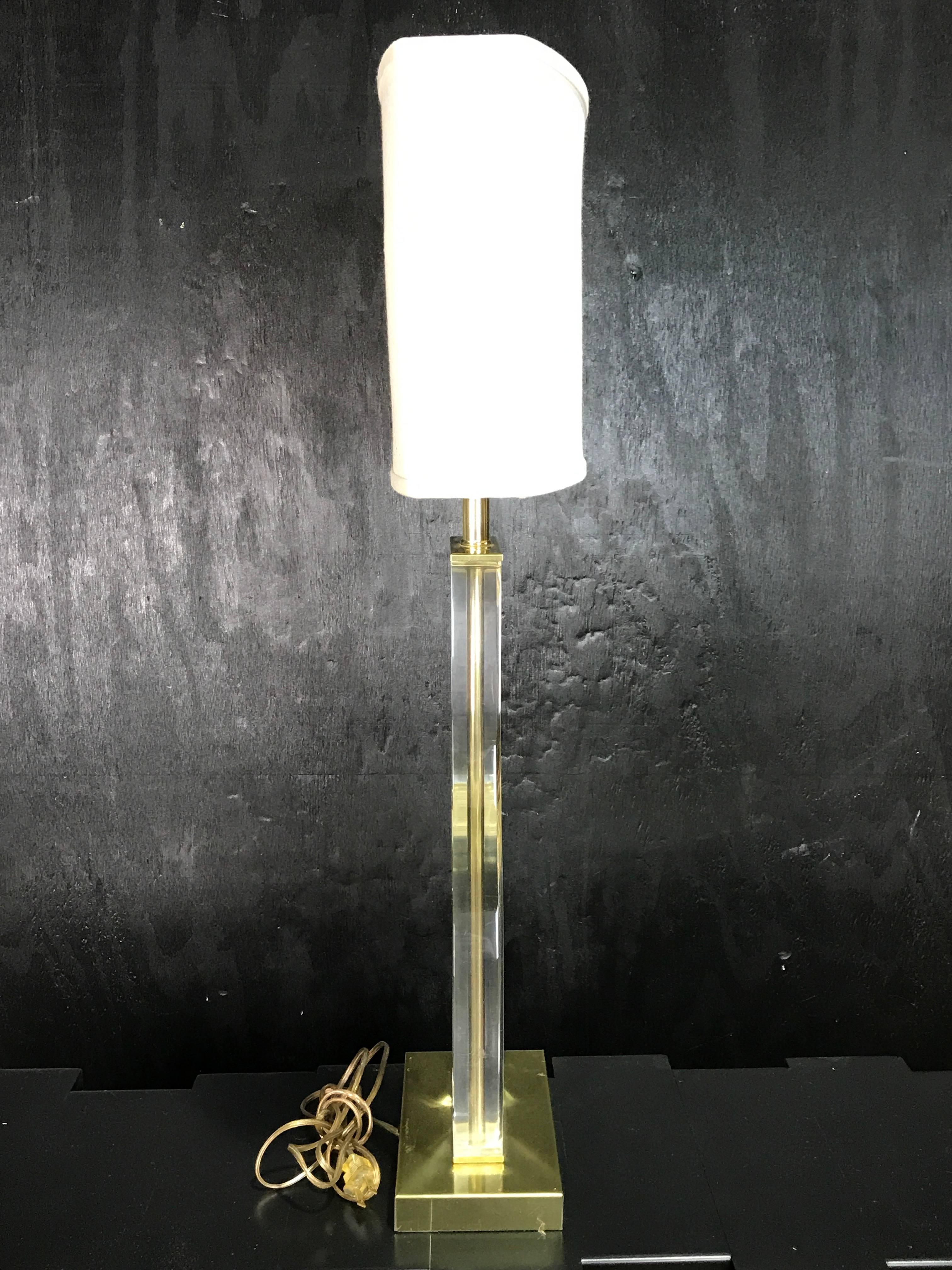 Pair of sculptural motif brass and Lucite table lamps, each one clear and crisp with brass mounts
18