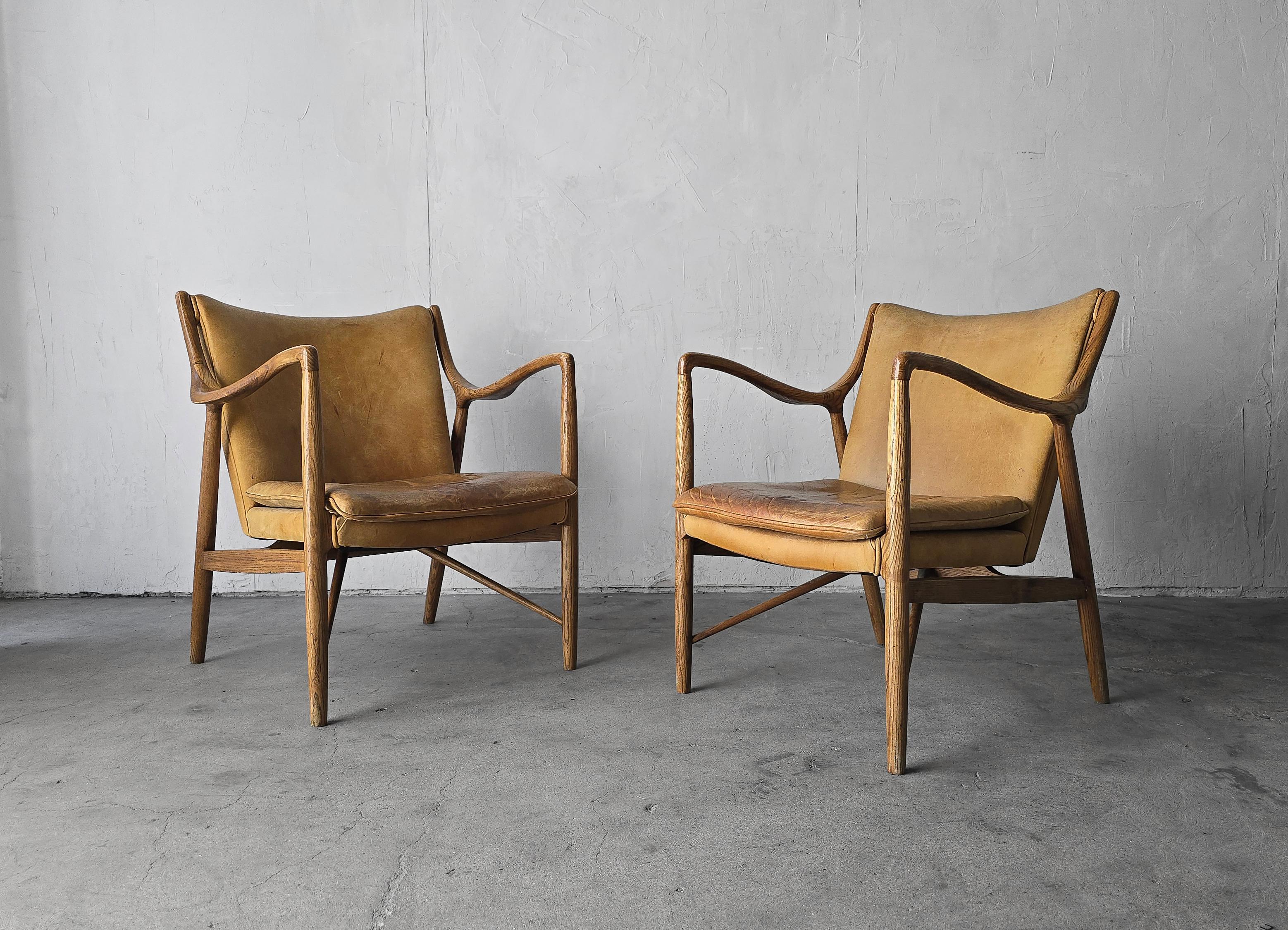 4 Chairs available, priced per Pair

Beautiful vintage, midcentury, Danish modern style lounge chairs after Finn Juhl's model 45 chair. Expertly crafted out of solid oak with beautiful grain and rounded feminine lines.  The leather is beautifully
