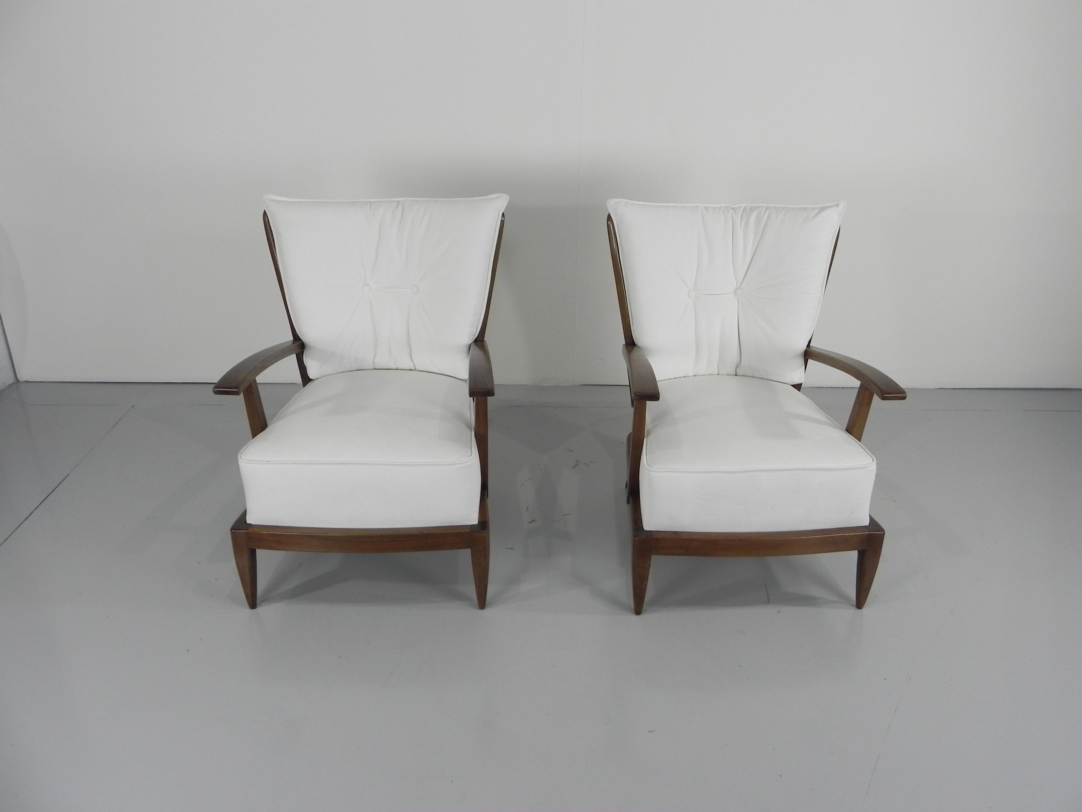 Paolo Buffa (1903-1970). Hübsches Paar nussbaumgebeizter Sessel mit spindelförmiger Rücken- und Armlehne, geschnitzten Armlehnen und konischen Beinen, Italien, um 1950.