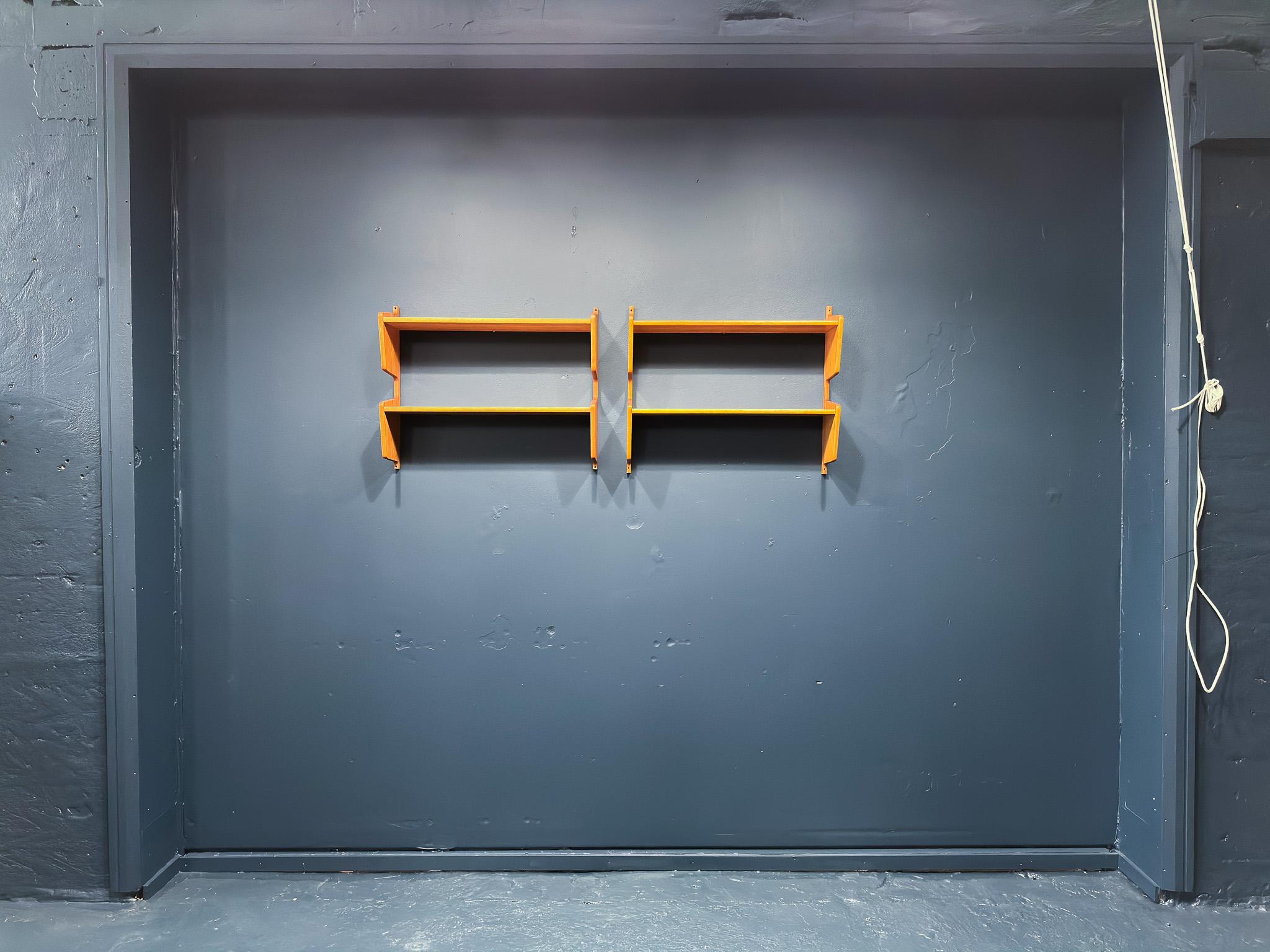 This gorgeous pair of mid-century pine shelves are excellently crafted, they are very structural in shape with curved angular frames. With fixings both at the top and bottom, the shelves can be hung in multiple ways, either to create a more