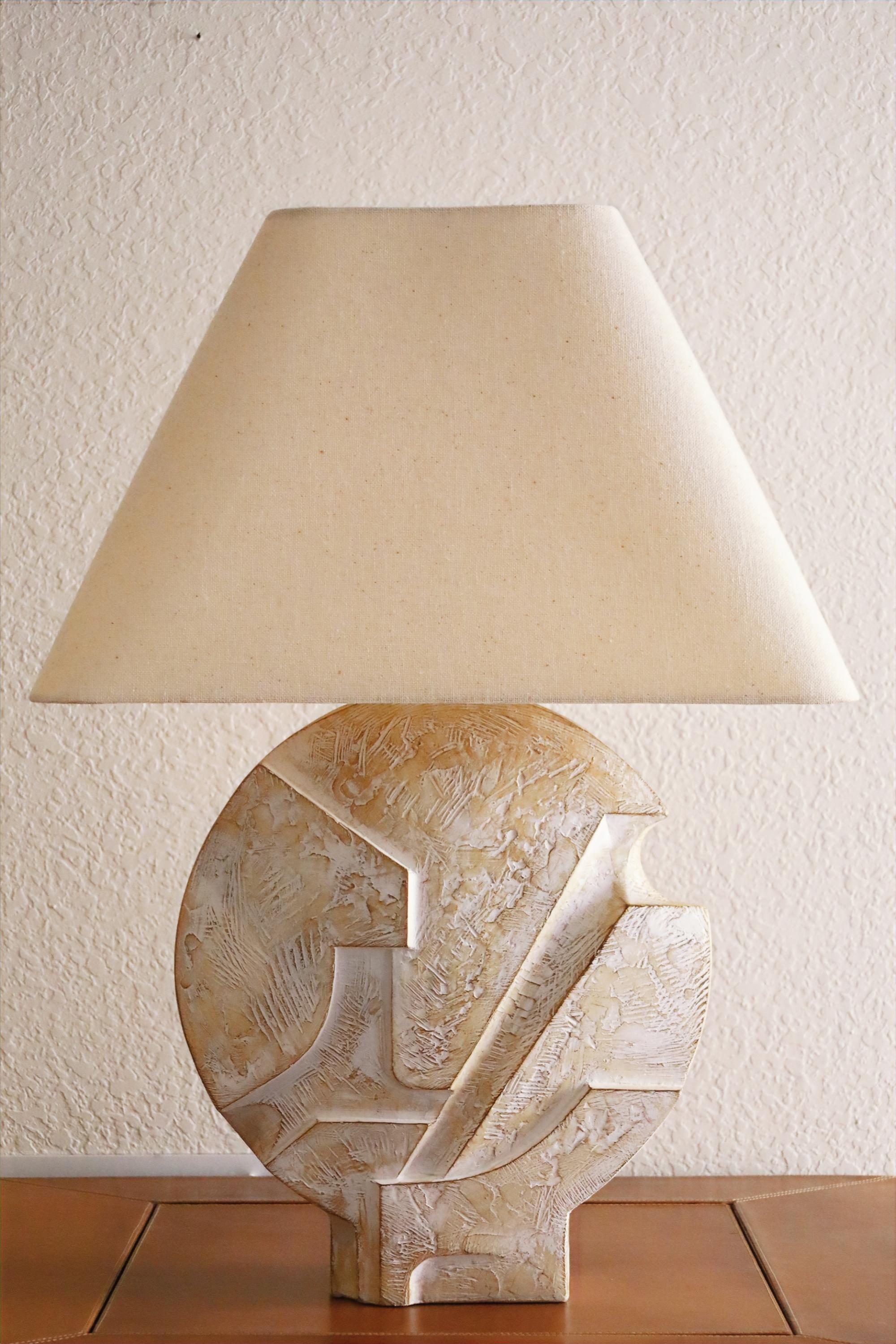 A monumental pair of sculptural plaster table lamps by Casual Lamps of California. These vintage brutalist style lamps are bold and unique, yet sophisticated. They are crafted from off-white cast plaster and have an incredible tactile texture, which