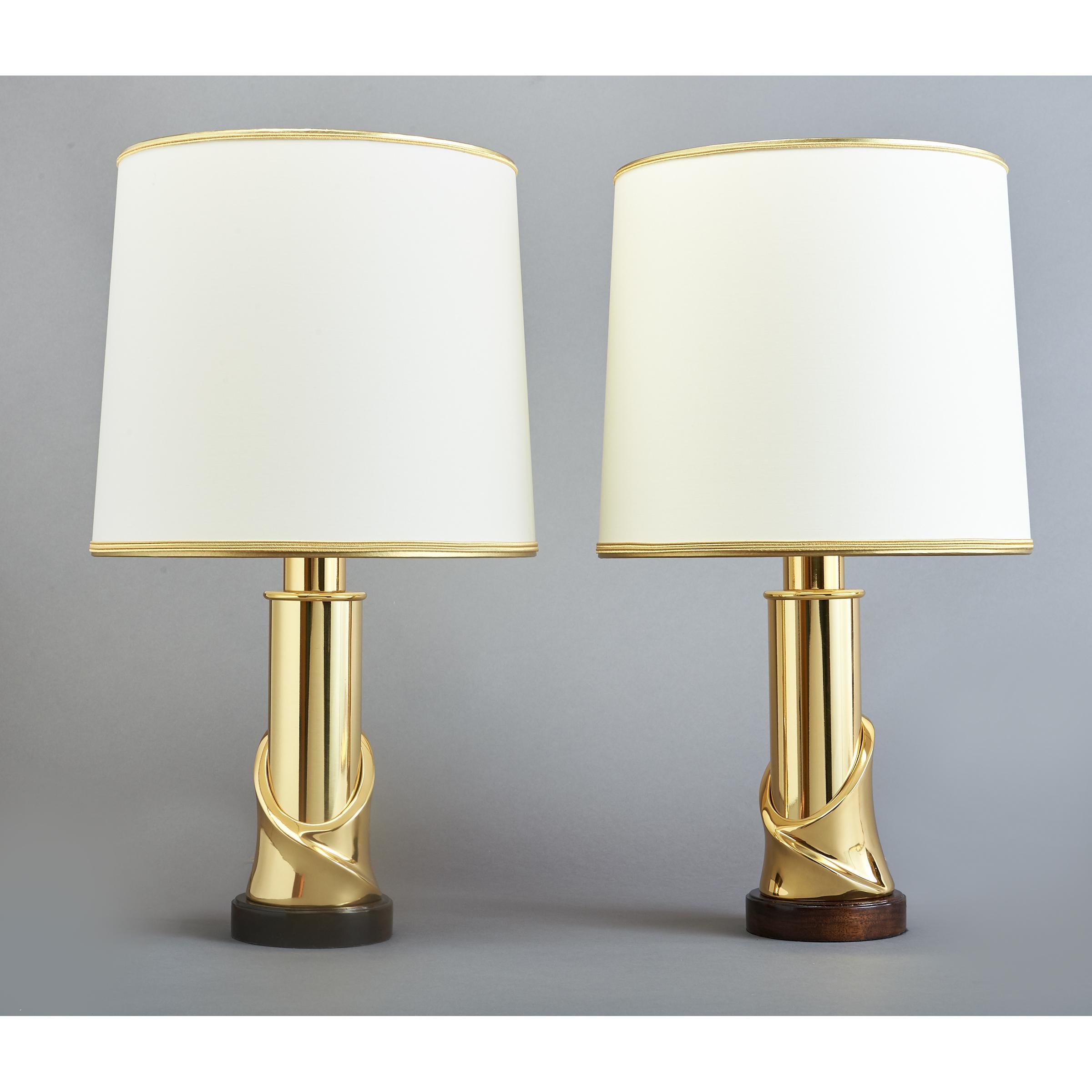 Italy, 1970's
Pair of polished brass table lamps with sculptural climbing spiral motif shaft on polished wood base.
Measures: diameter 11 x 20 height
Rewired for use in the US with one standard base bulb
New round fabric shade, with elegant trim.