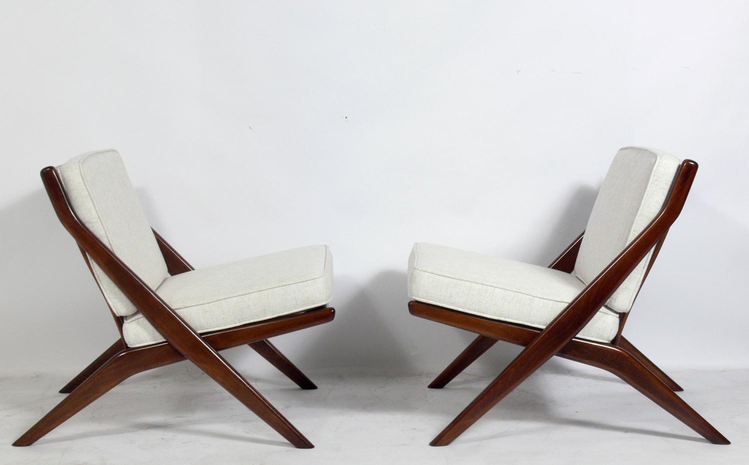 Pair of Danish modern sculptural scissor chairs, designed by Folke Ohlsson for DUX, circa 1960s. Refinished and reupholstered in an ivory color herringbone upholstery.