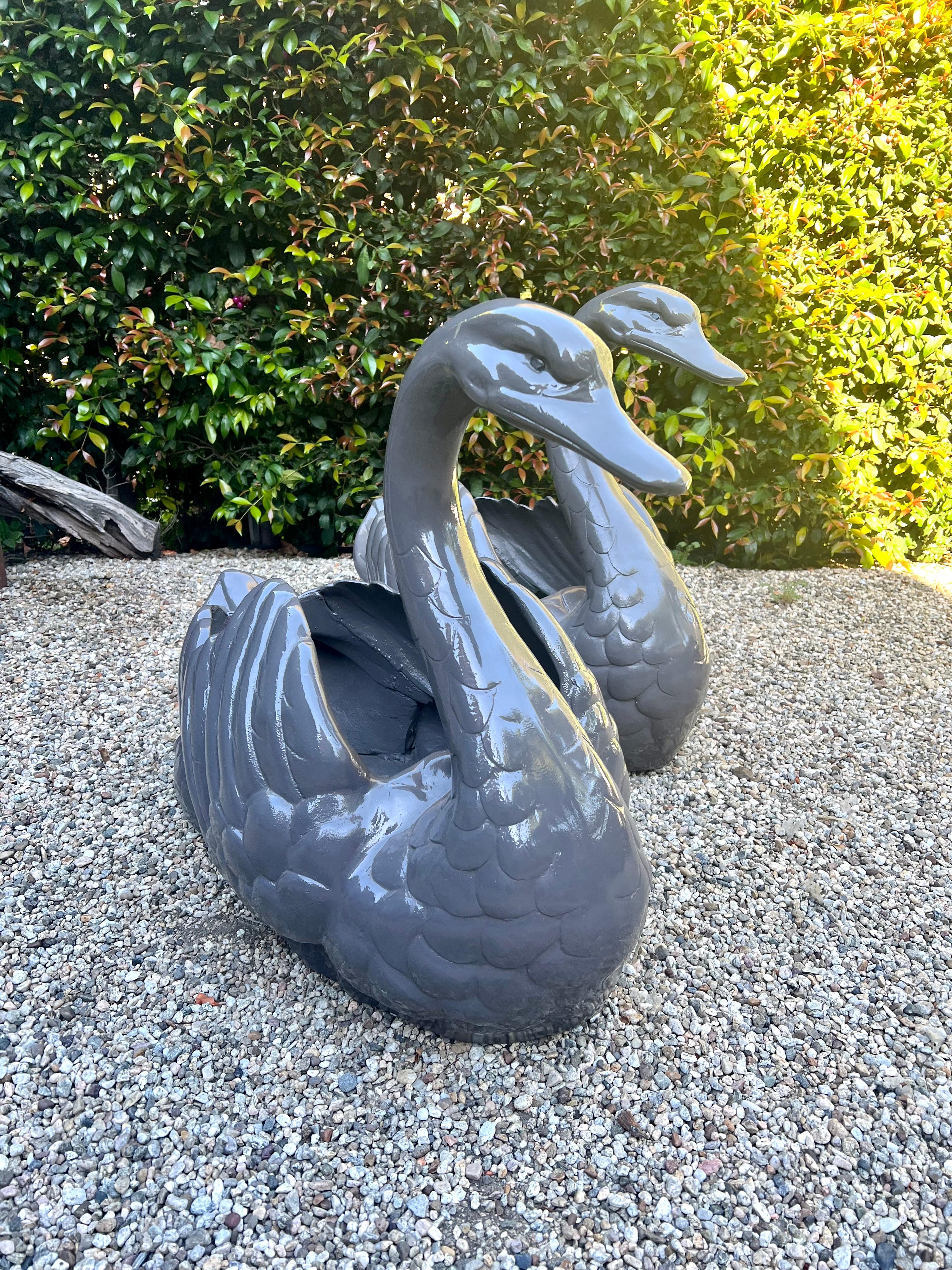 Pair of oversized Garden Planters or Jardinieres in the shape of a swan. Details of the face and feathers are both well done and graceful.

The pair make a lovely addition to any garden or patio setting - they can add to a very sophisticated space