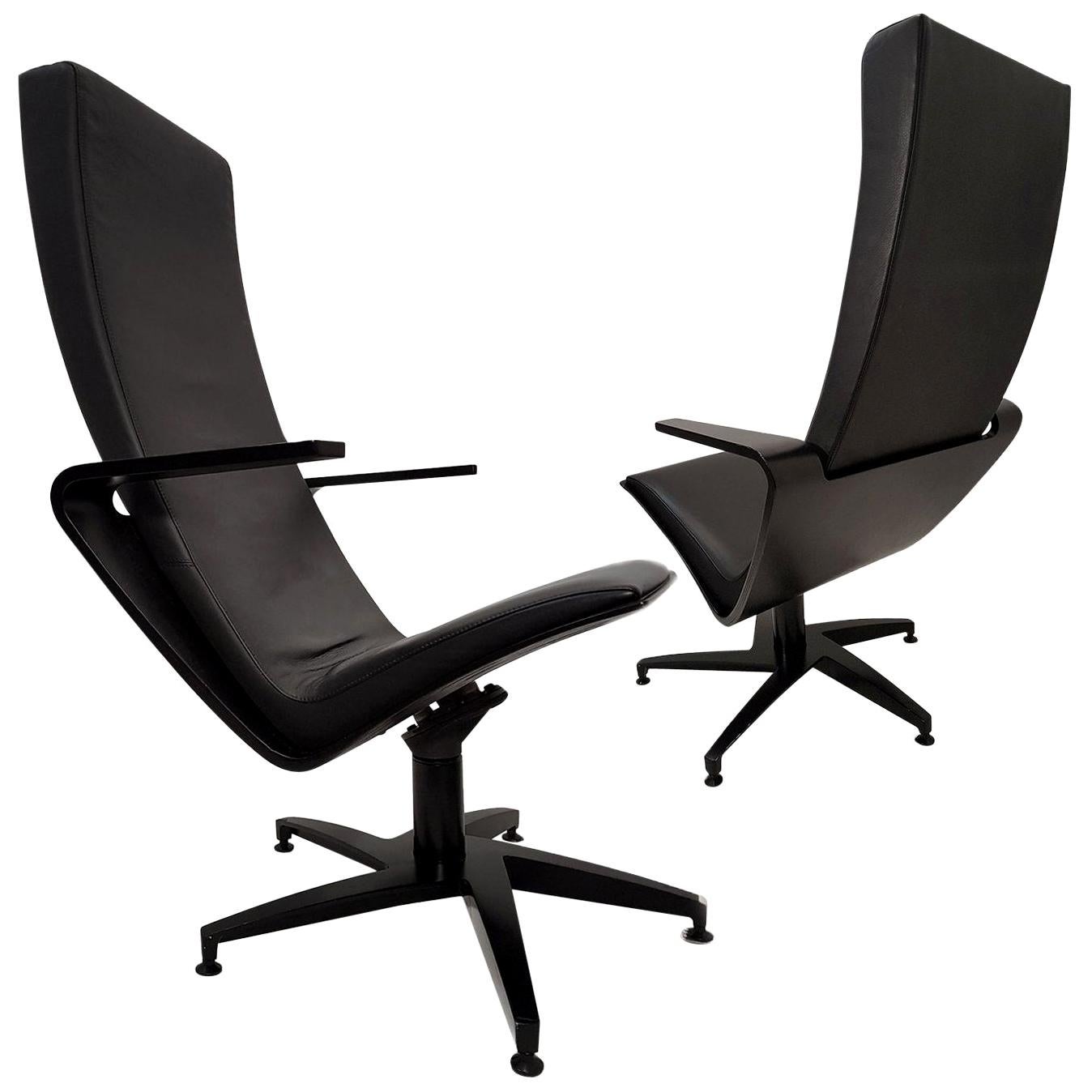 A pair of sculptural, swiveling lounge chairs. Base of black cast aluminium, seat shell of birch plywood stained in black. Damper mechanism under the seat. Upholstered with high-end quality black leather. Very comfortable seat. 

Design Pentti