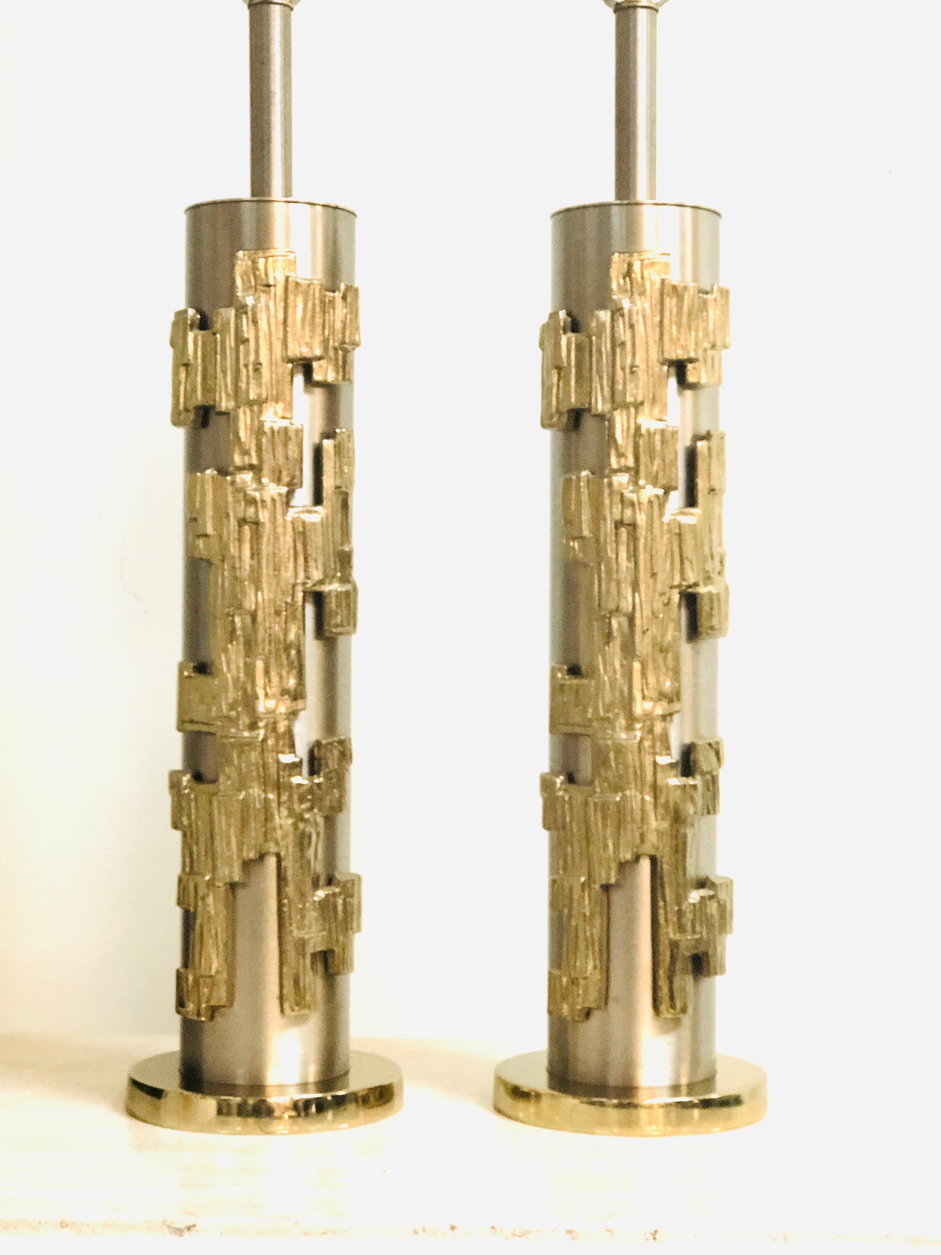 A pair of modernist table lamps by Laurel. The cylindrical bodies have a brushed nickel finished. The abstract sculptural elements are done in an light brass finish. Stunning lamps. 37