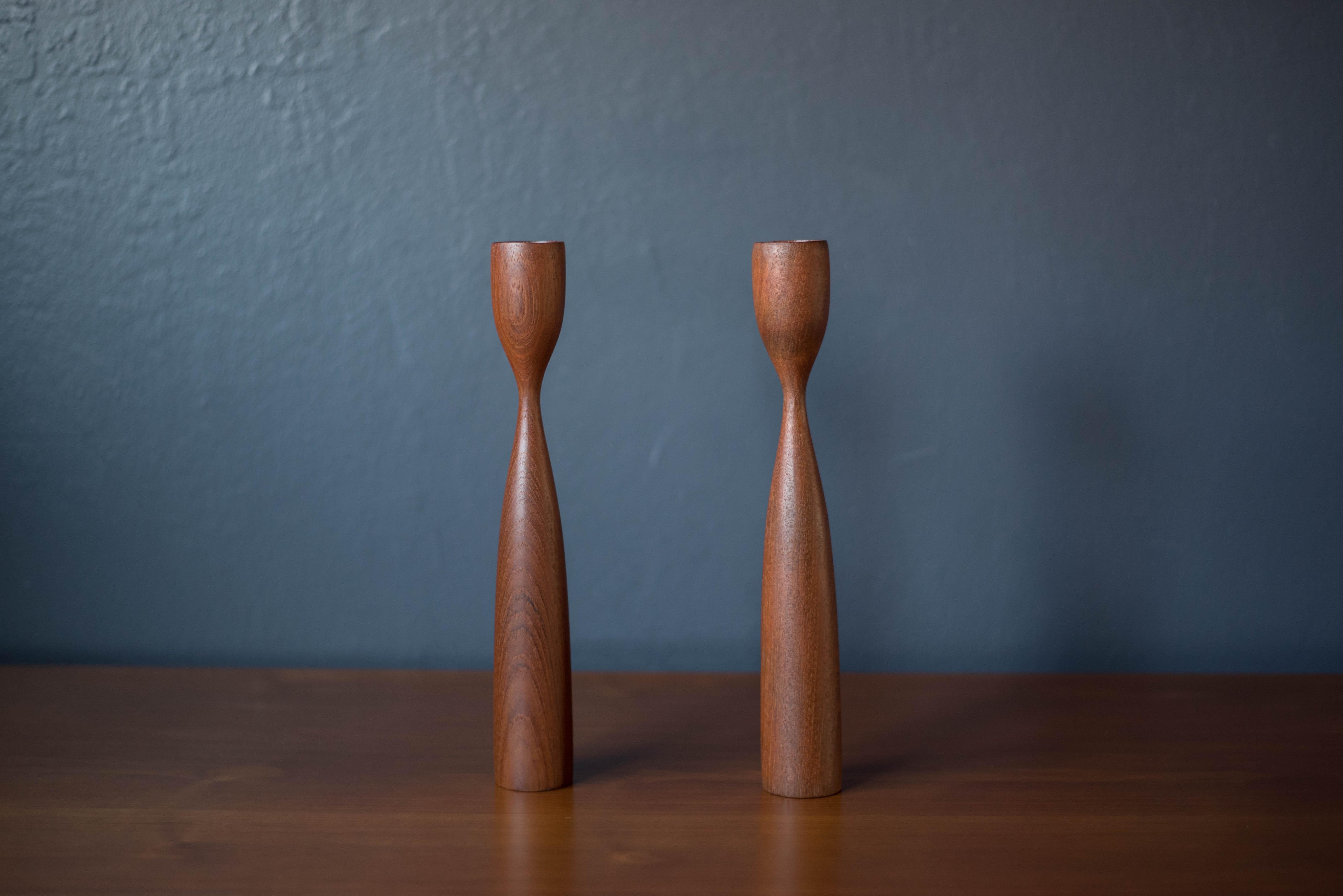 Vintage pair of Danish modern teak candleholders circa 1960's. This set displays well with any modern home decor and fits 7/8
