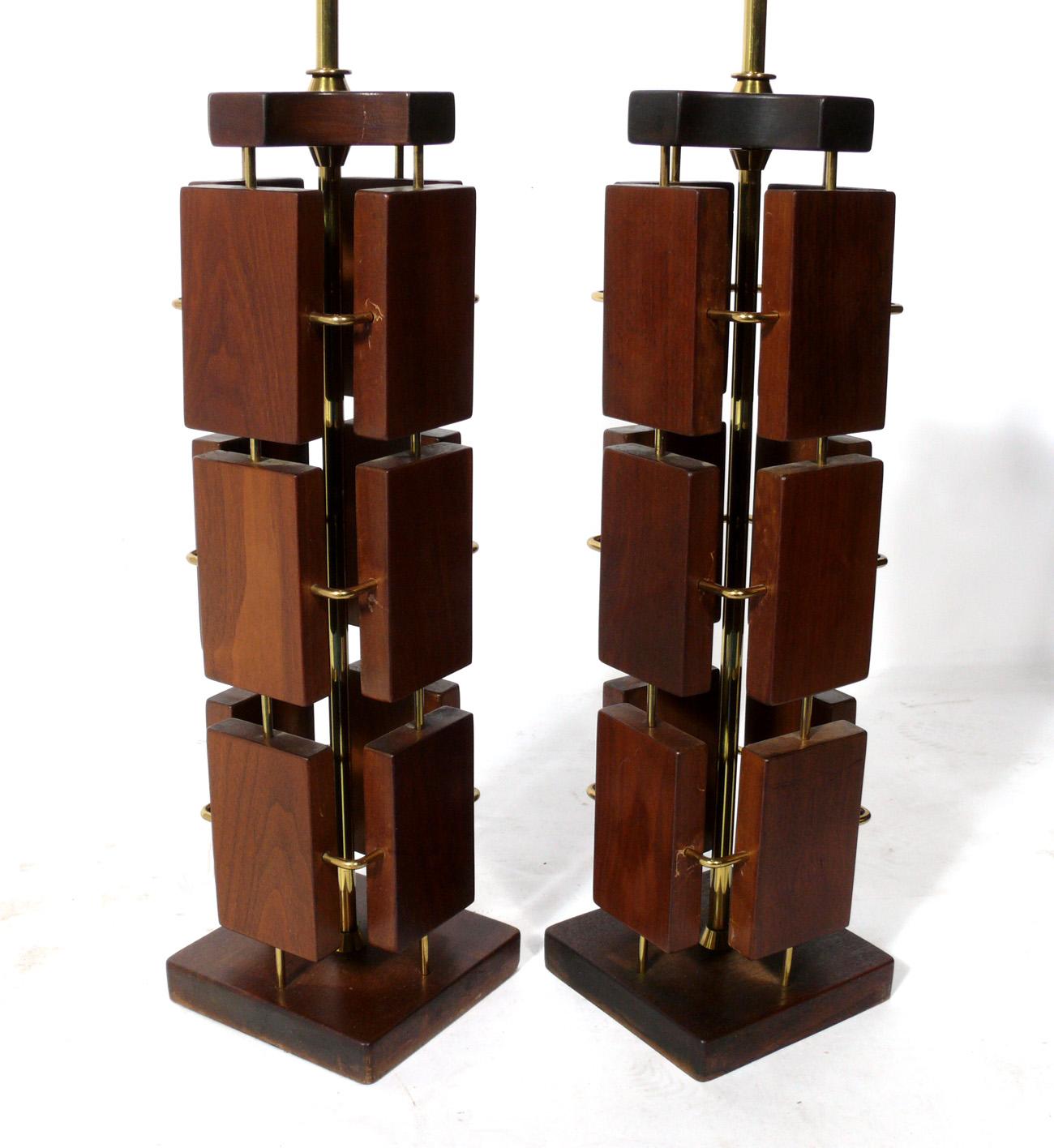 Pair of sculptural walnut and brass Mid-Century Modern lamps. American, circa 1960s. They have been rewired and are ready to use. The price noted below includes the shades.