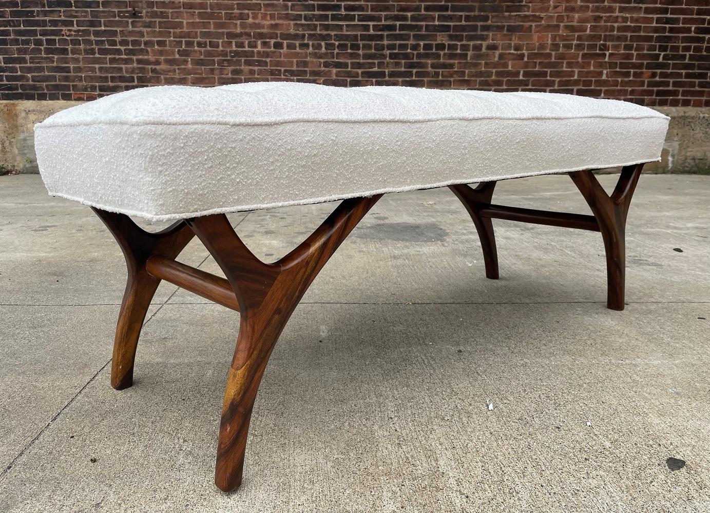 Sculptural walnut bench upholstered in Boucle. By the each.  Kagan style.