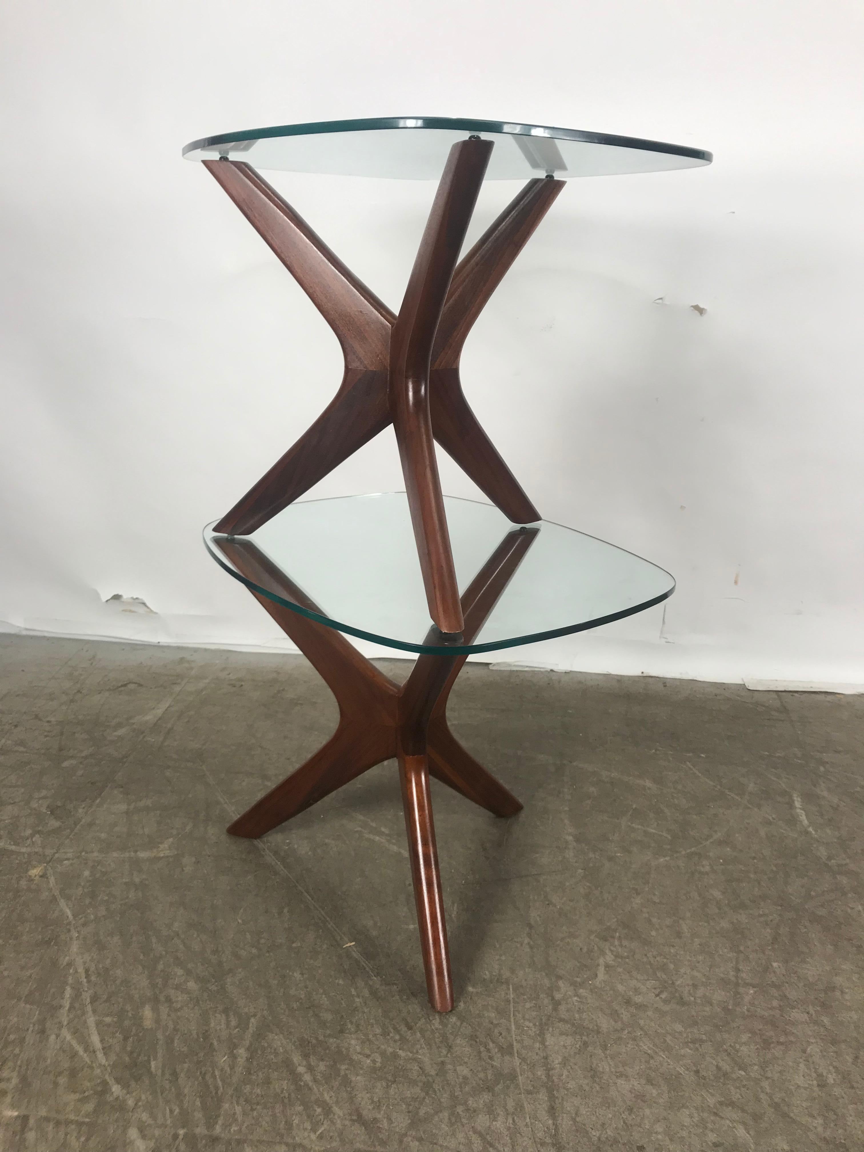 Classic Mid-Century Modern sculptural lamp tables, each with interlocking boomerang form walnut bases supporting asymmetrically flared square glass tops. By Adrian Pearsall for Craft Associates, American, circa 1950.