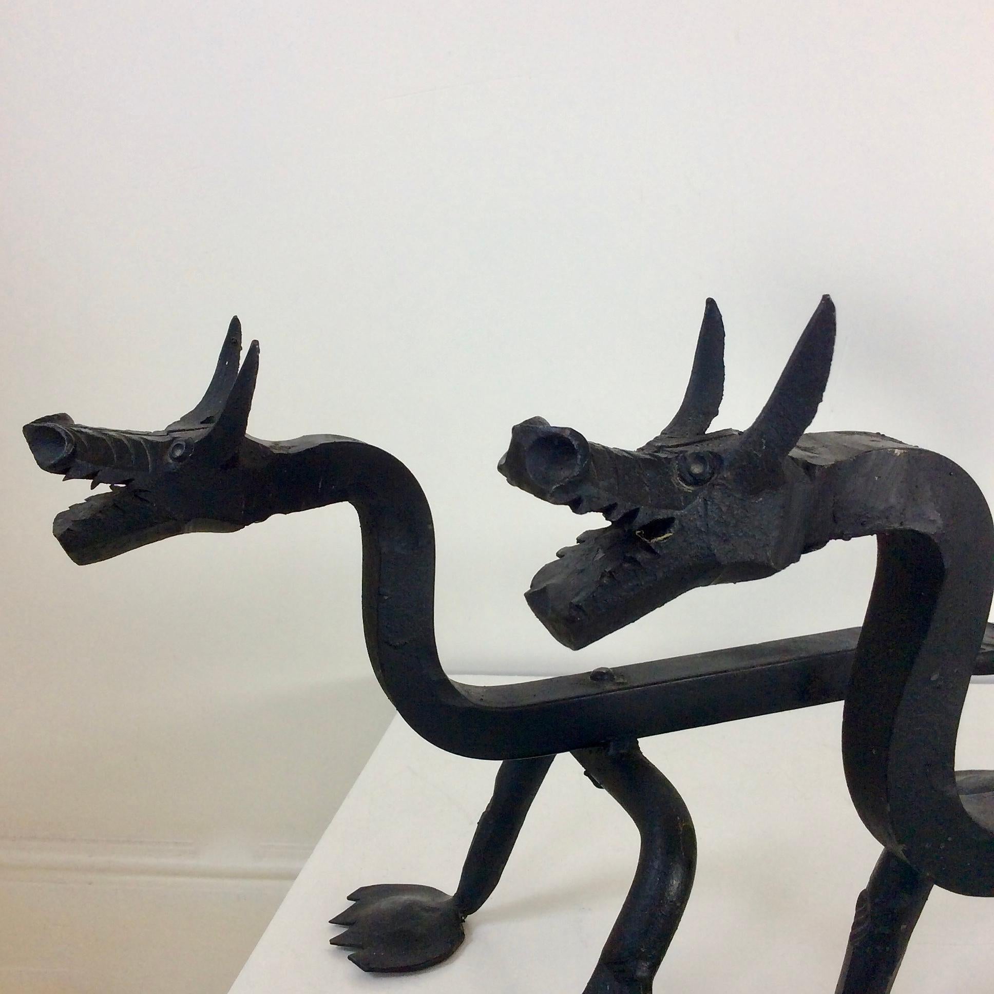 Blackened Sculptural Wrought Iron Pair Of Dragons Andirons, circa 1910.