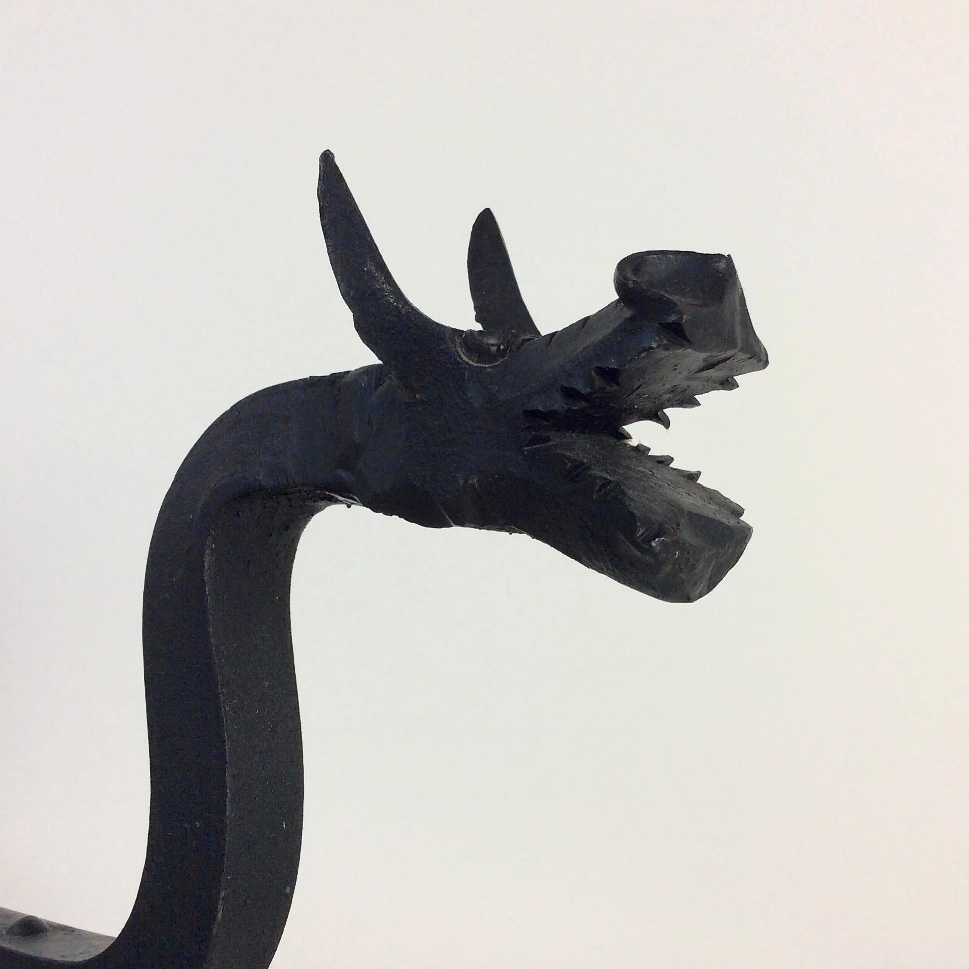 20th Century Sculptural Wrought Iron Pair Of Dragons Andirons, circa 1910.