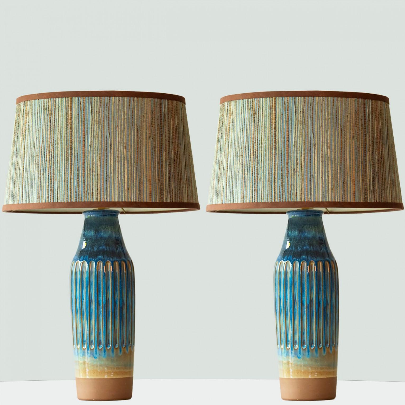 Pair of heavy quality ceramic table lamps,  1970s.

This lamp base brings refined elegance and rich visual appeal to any interior. With its beautiful shape, it offers a unique presence.

This base with sea blue and sand brown shades fits perfectly