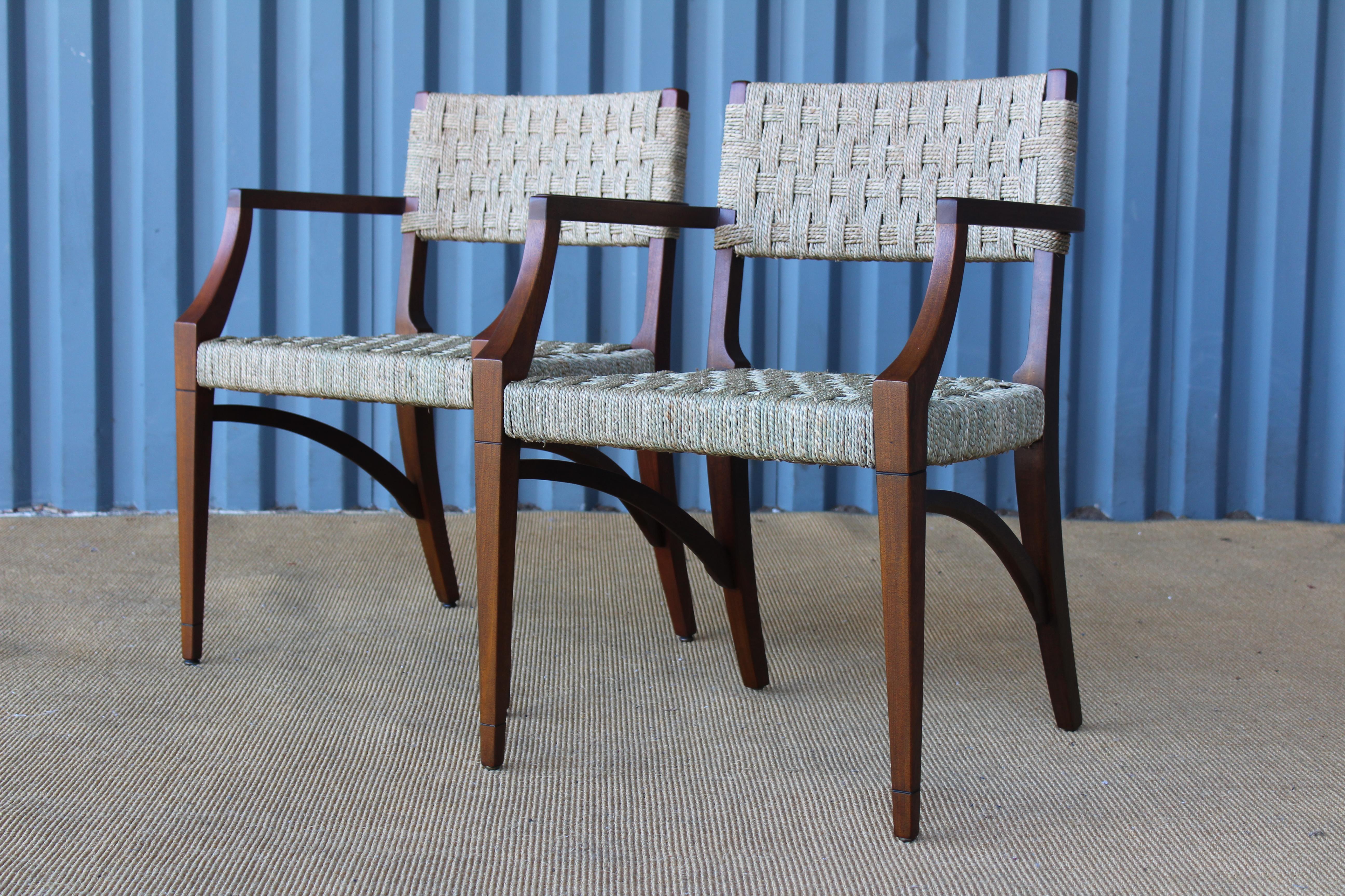 Pair of mahogany and sea grass armchairs, in the manner of Audoux-Minet, France, 1950s. The pair have both been refinished and have new woven sea grass seats and backrests.