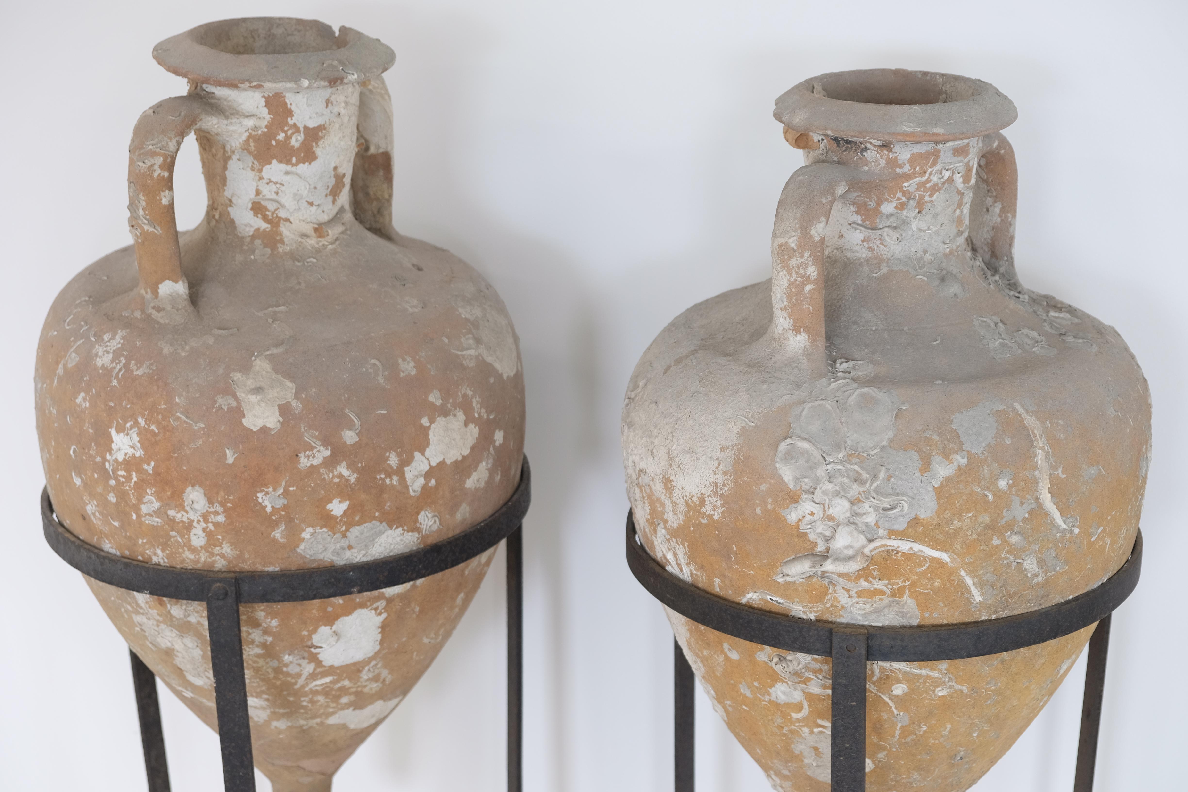 18th Century and Earlier Pair of Sea Salvaged Roman Amphorae with 19th Century Wrought Iron Stands