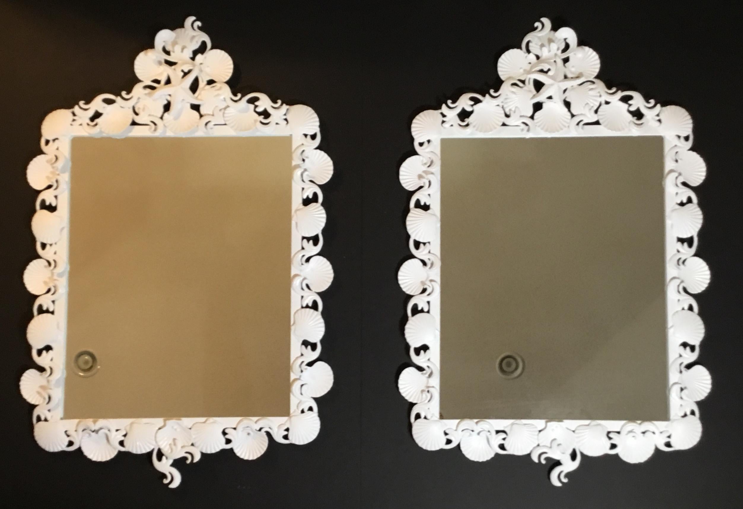 Fantastic pair of mirrors made of iron artistically decorated with sea shell and sea star motifs, painted in white lacquer.
Will sell single mirror upon request.
Actual mirror size: 28” x 22”.5.