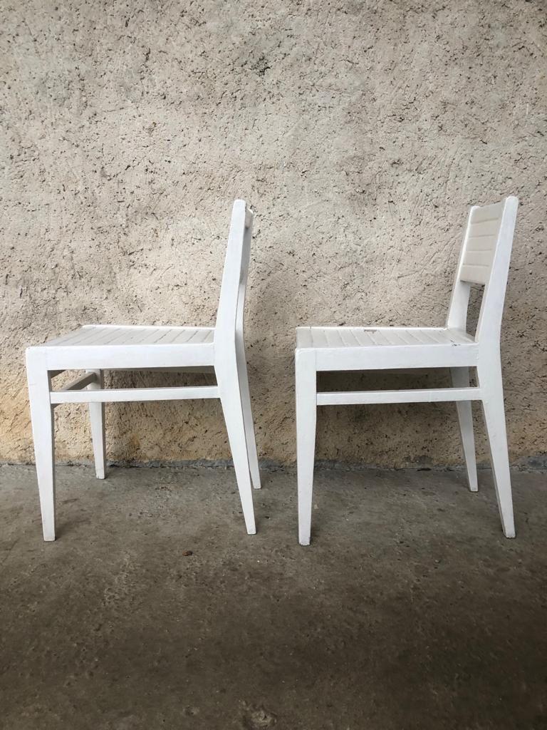 A pair of small succession chairs painted white, circa 1920.