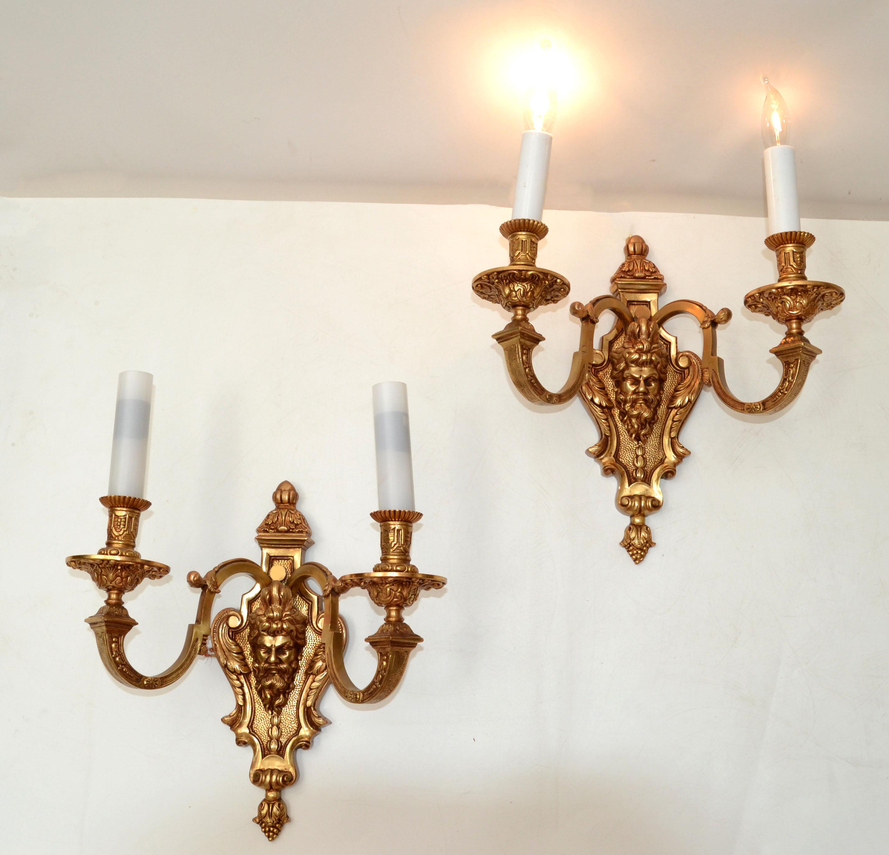 Pair of second Empire heavy 2 light solid polished bronze dore sconces, light fixture, wall lamps from the late 19th century.
Depict face motif in the middle and Grape Finial at the bottom tip.
UL Listed and US wiring and each takes 2 light bulbs