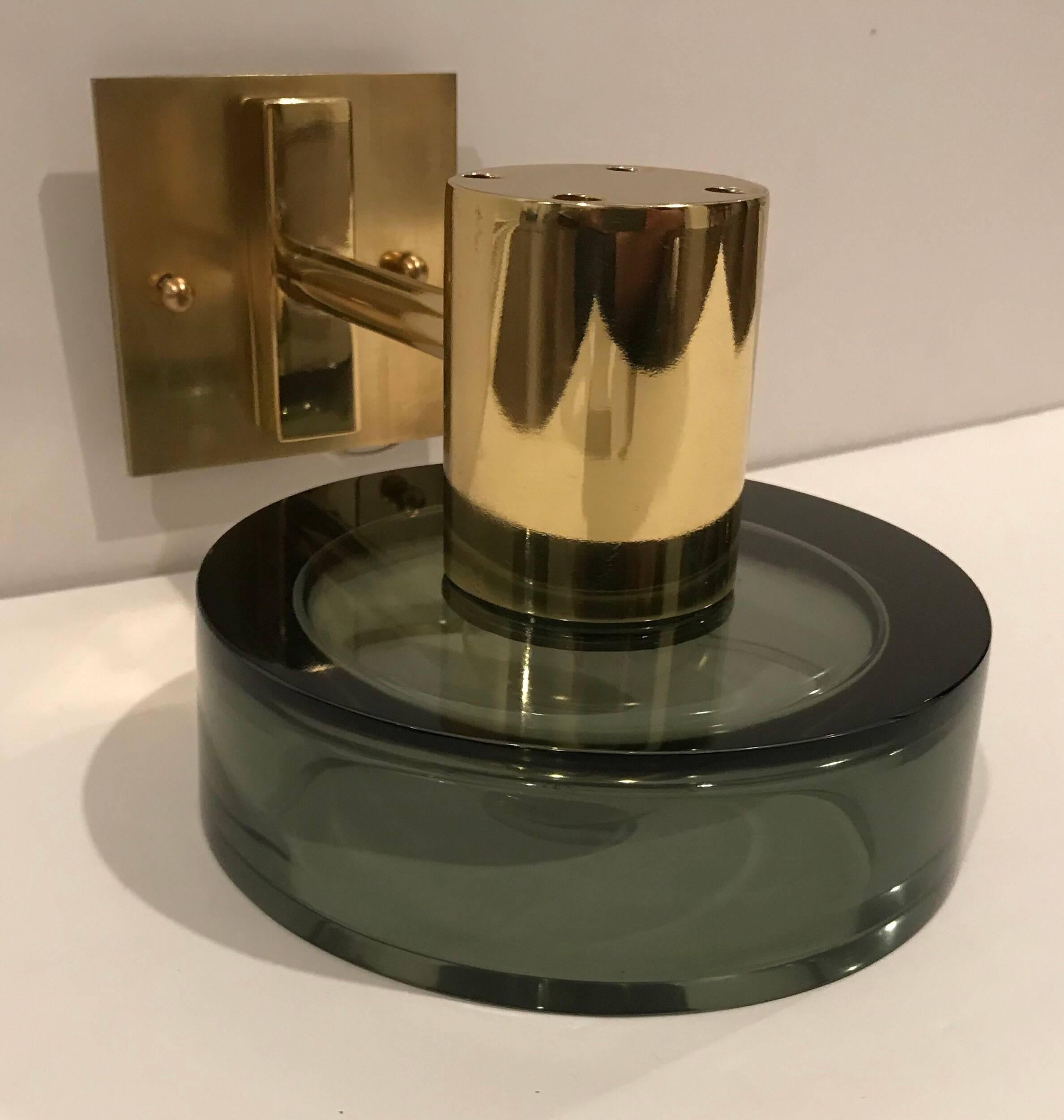 A pair of 1960s wall lights composed of thick Murano glass olive green shades with golden polished brass fixtures and wall plates by Seguso. Newly rewired. Excellent shape.