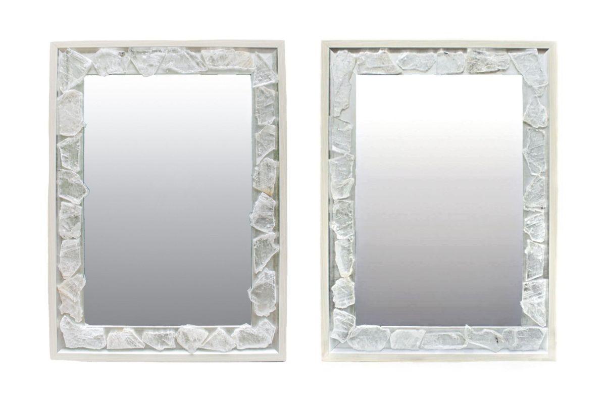 Pair of selenite mirrors by Interi.

The silver and cream frames are adorned with selenite slices. Selenite is a crystallized form of gypsum. It is comprised of striations which look like optical light fibers. Although selenite comes in many