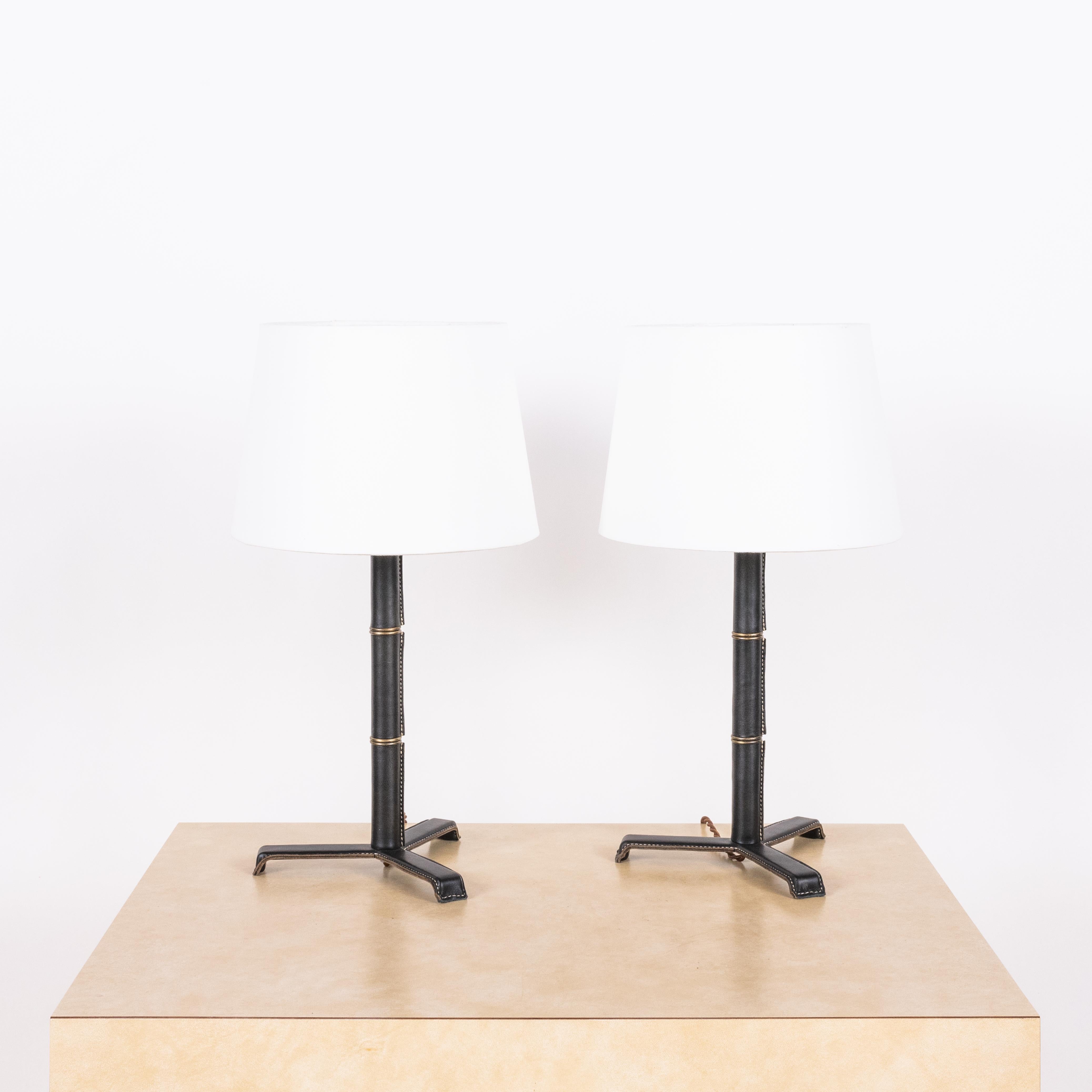 Introducing the 'Sellier' French modernist-style stitched black leather table lamps by Design Frères.

Crafted from premium black leather, the stitched detailing adds a touch of sophistication, while the parchment paper shade emits a warm and