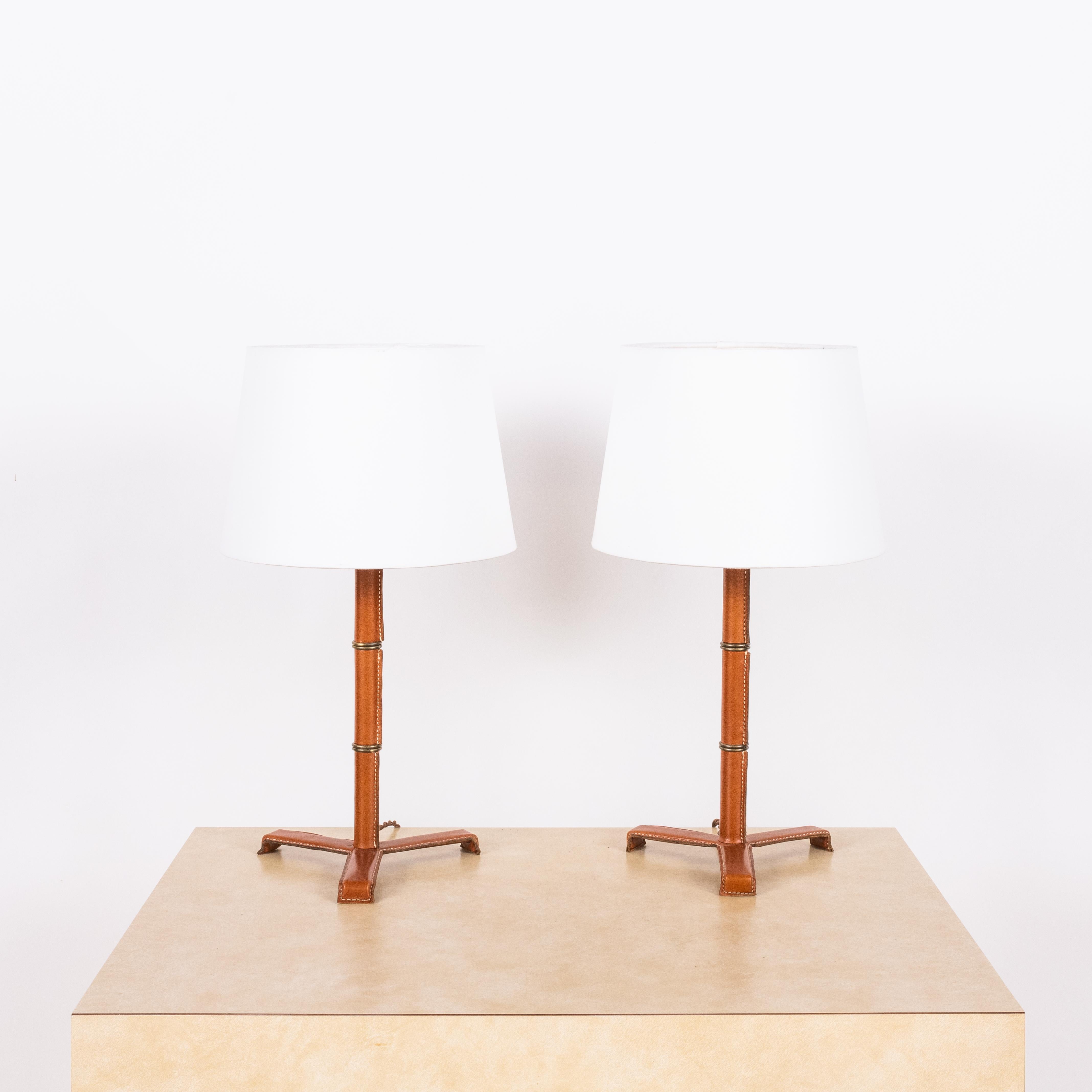 Introducing the 'Sellier' French modernist-style stitched tan leather table lamps by Design Frères.

Crafted from premium black leather, the stitched detailing adds a touch of sophistication, while the parchment paper shade emits a warm and inviting