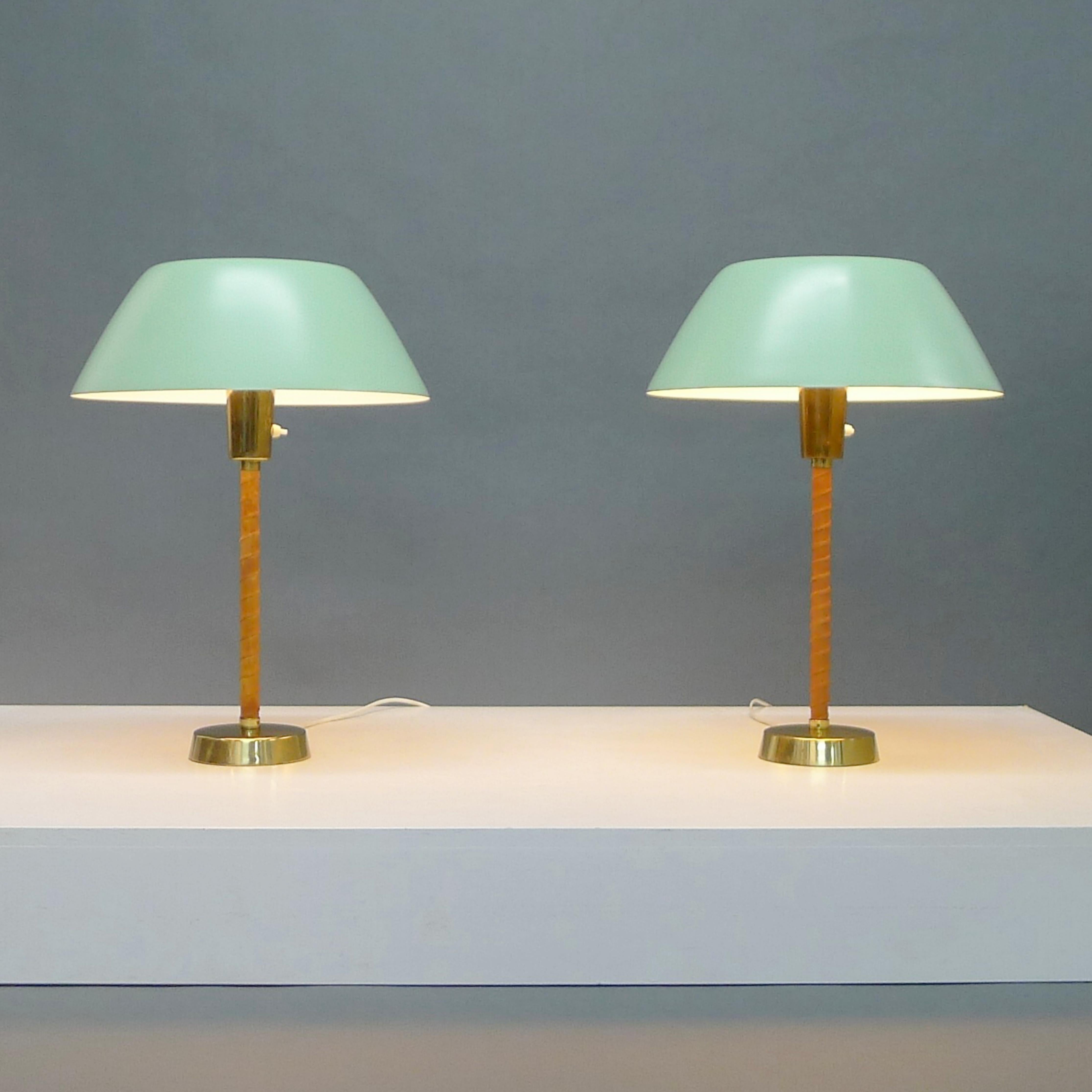Elegant pair of Senator table lamps, designed by Lisa Johansson-Pape in 1947 and manufactured by Stockmann-Orno Oy, Finland.

Each spun aluminium shade lacquered in a sea foam green colour rests on a white acrylic diffuser, raised on a leather
