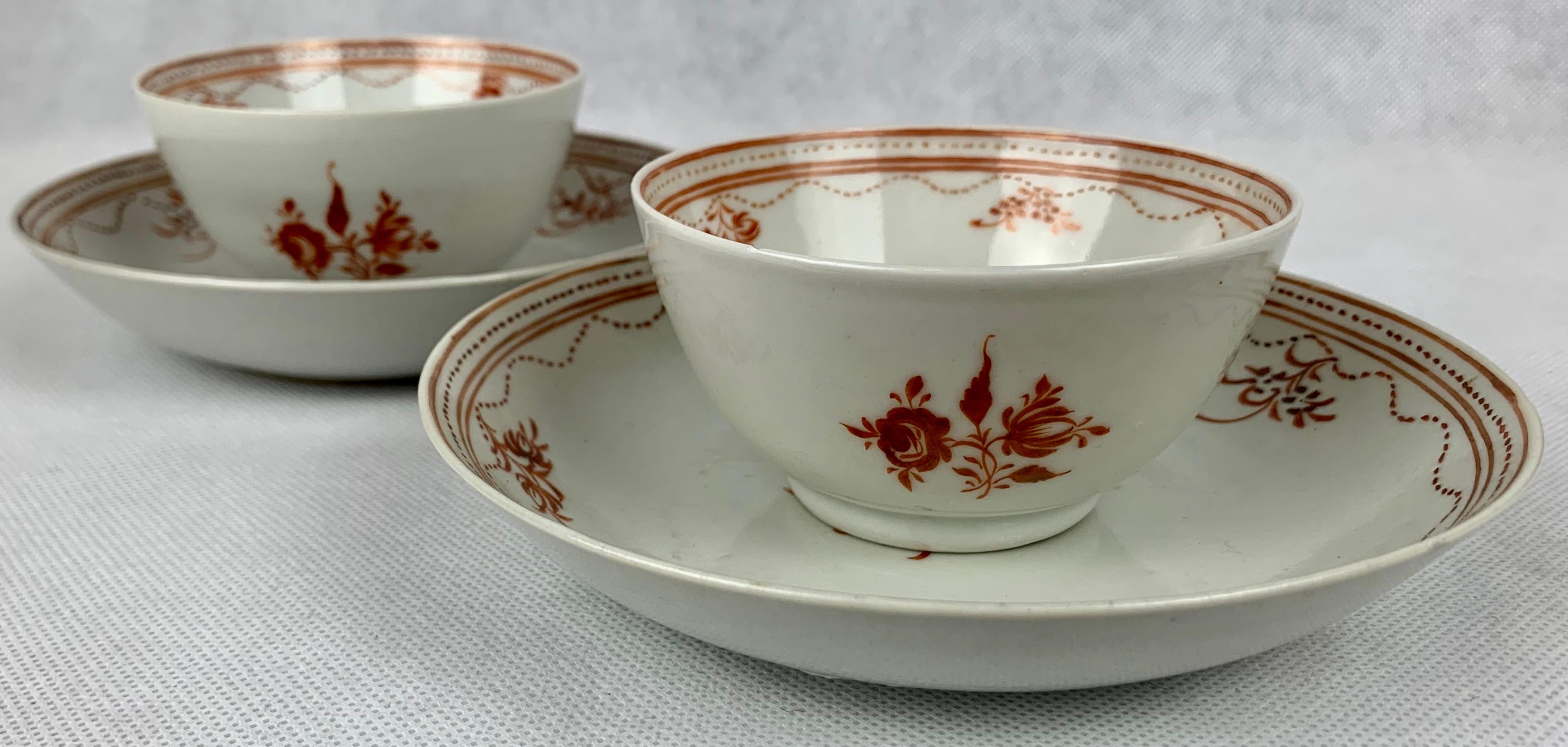 Pair of late 18th century handleless Chinese export cups and saucers. Hand decorated in tones of sepia with roses and other flowers. The borders are delicately decorated with a double line enclosing dots and a swagged dotted design. 
Measurements: